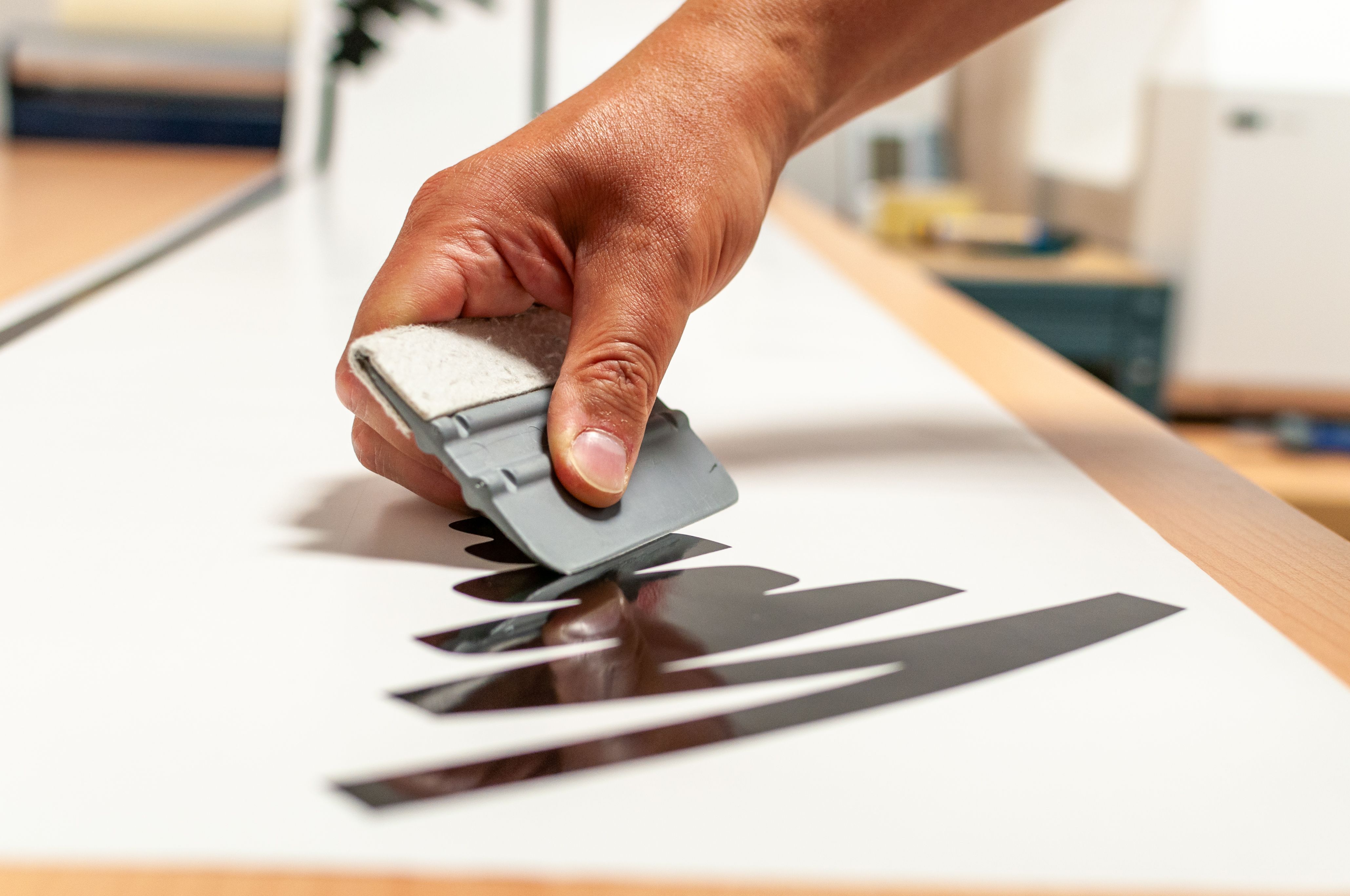 Close-up of the hand of a person making advertising stickers