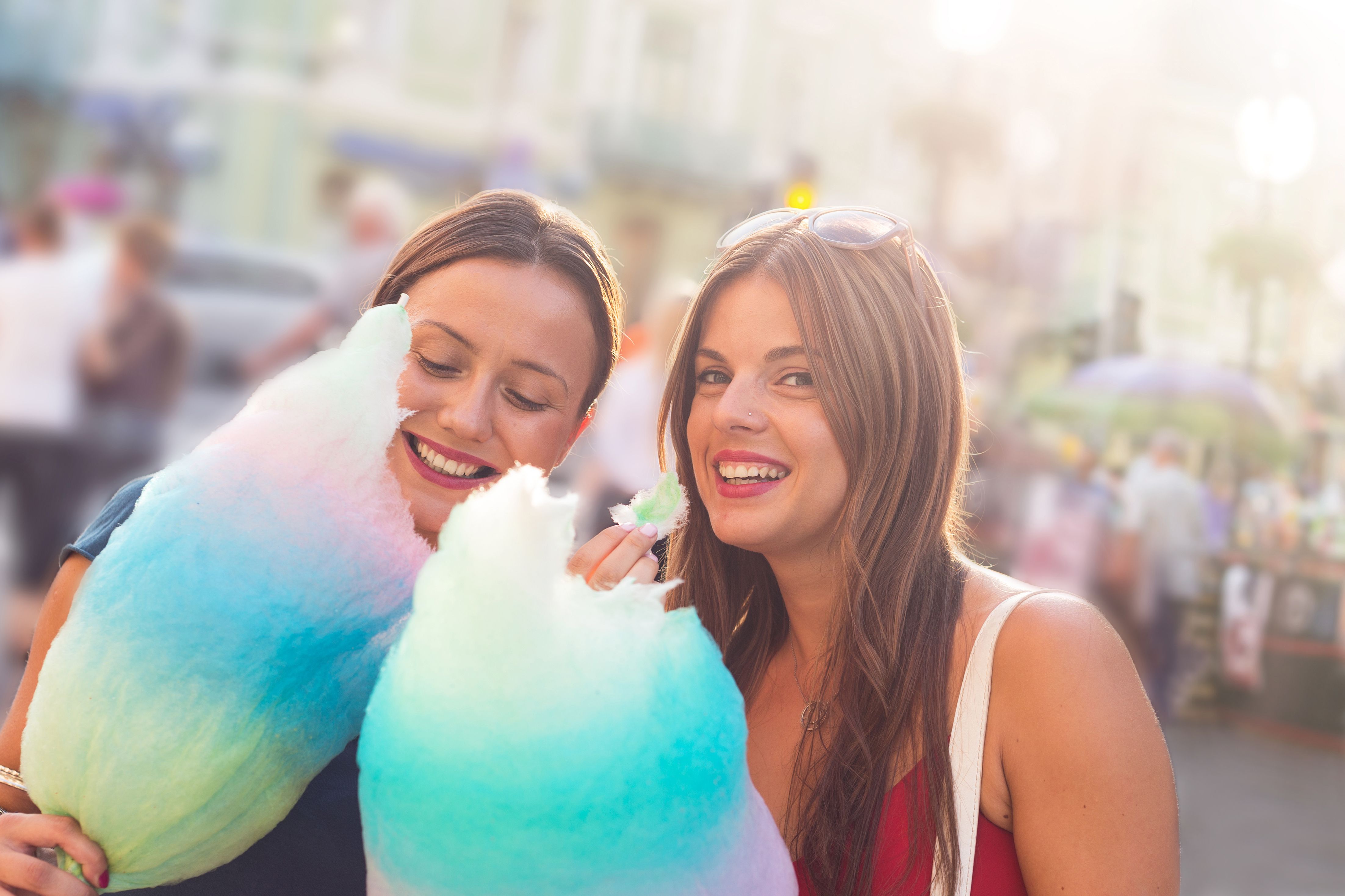 young women eating cotton candy and enjoying