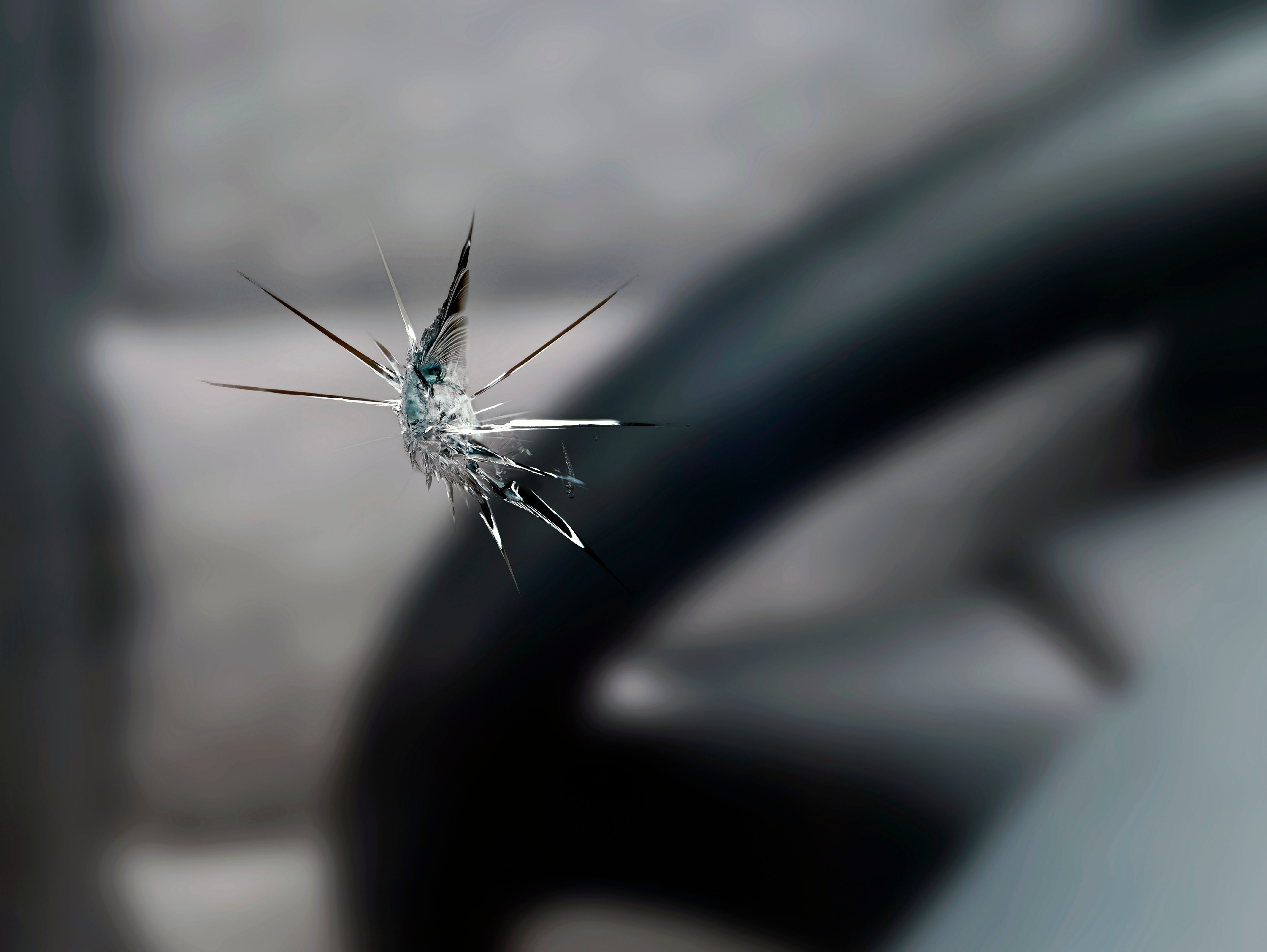 close up of a stone chip in the windshield of a car, detail shot of cracks in car glass on the drivers side close up of a stone chip in the windshield of a car, detail shot of cracks in car glass on the drivers side