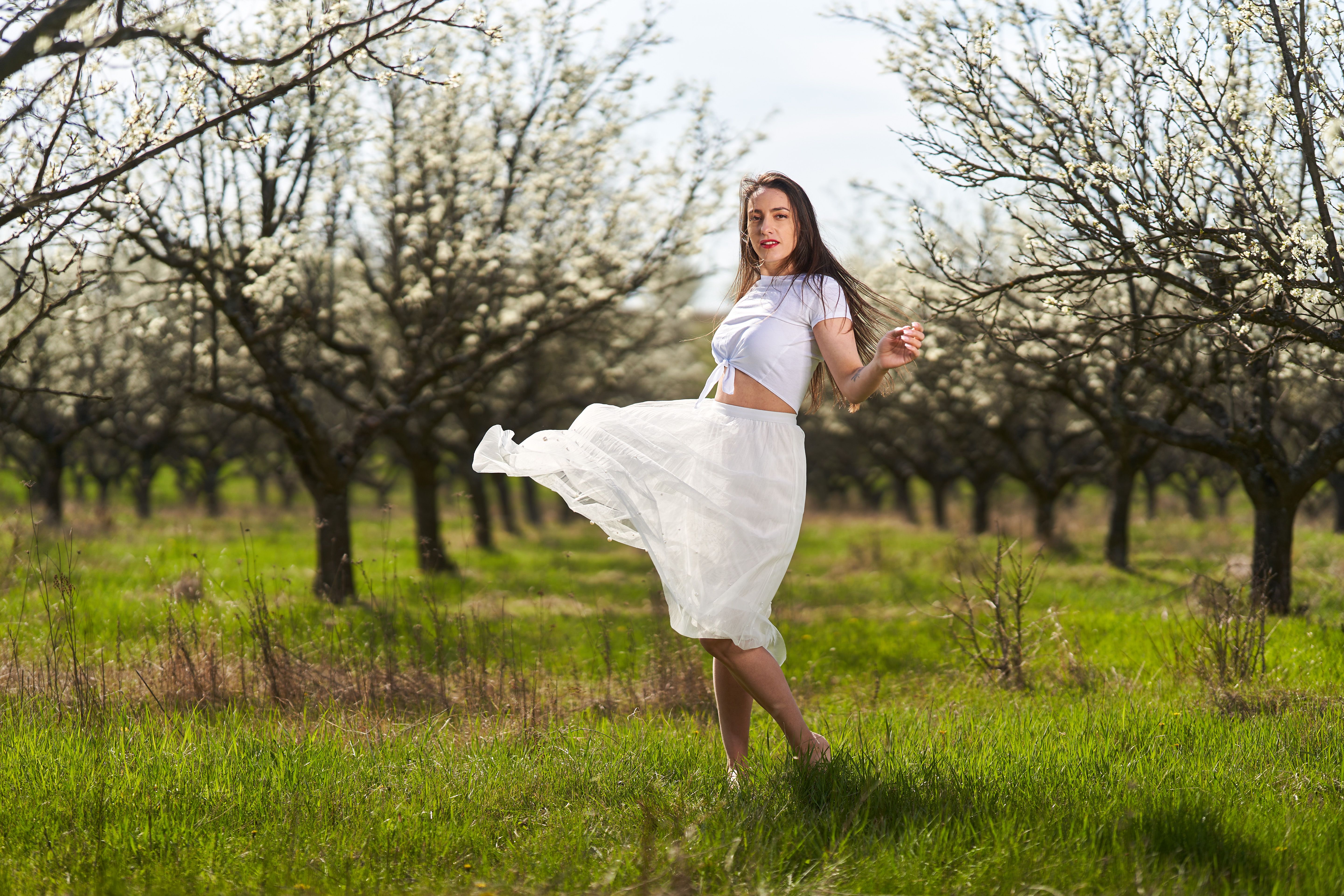Beautiful woman in a plum orchard in bloom