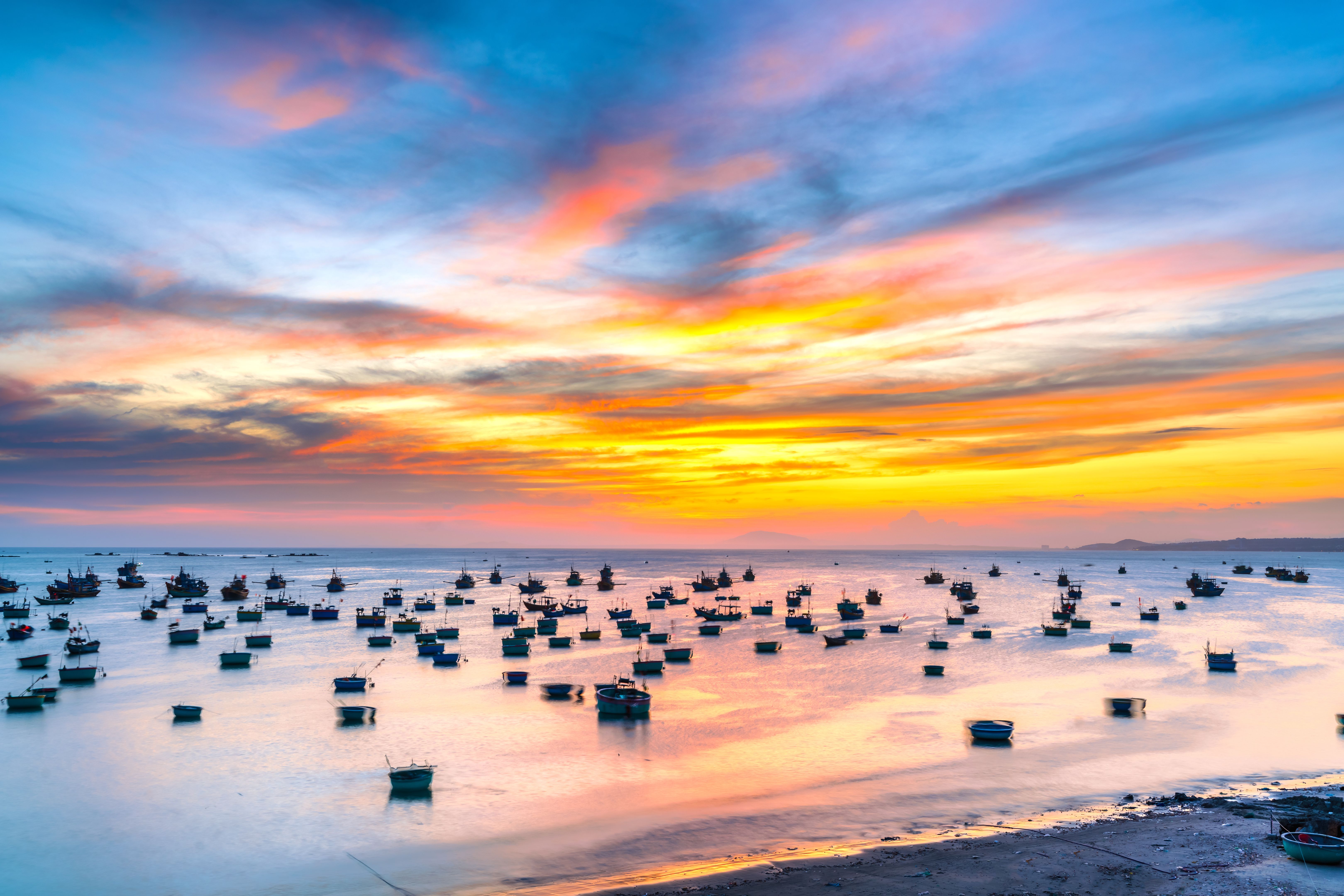 Mui Ne fishing village in sunset sky with hundreds of boats anchored to avoid storms Mui Ne fishing village in sunset sky with hundreds of boats anchored to avoid storms