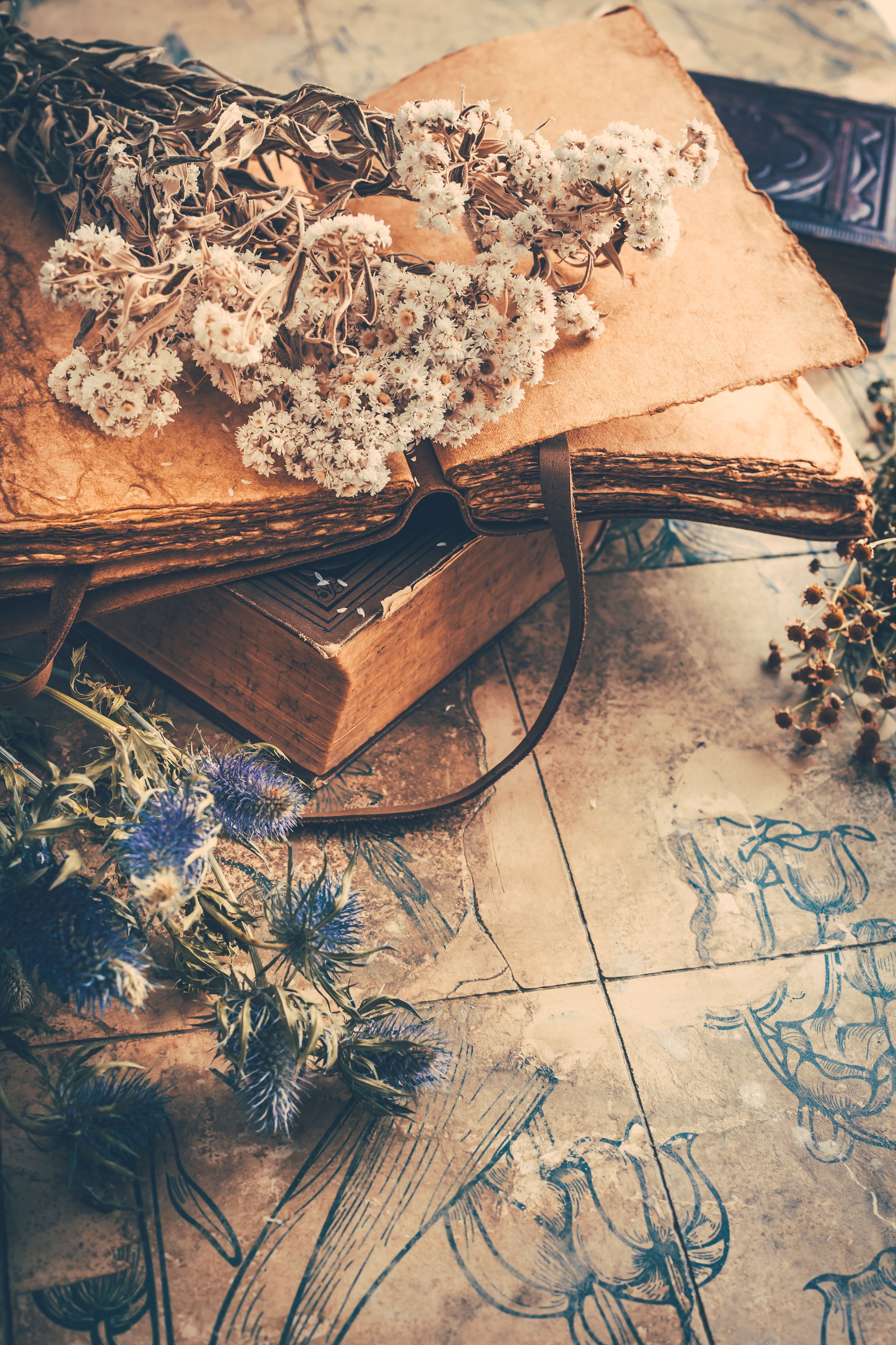 Dry flowers bouquets with old vintage diary and books, nostalgic vintage background