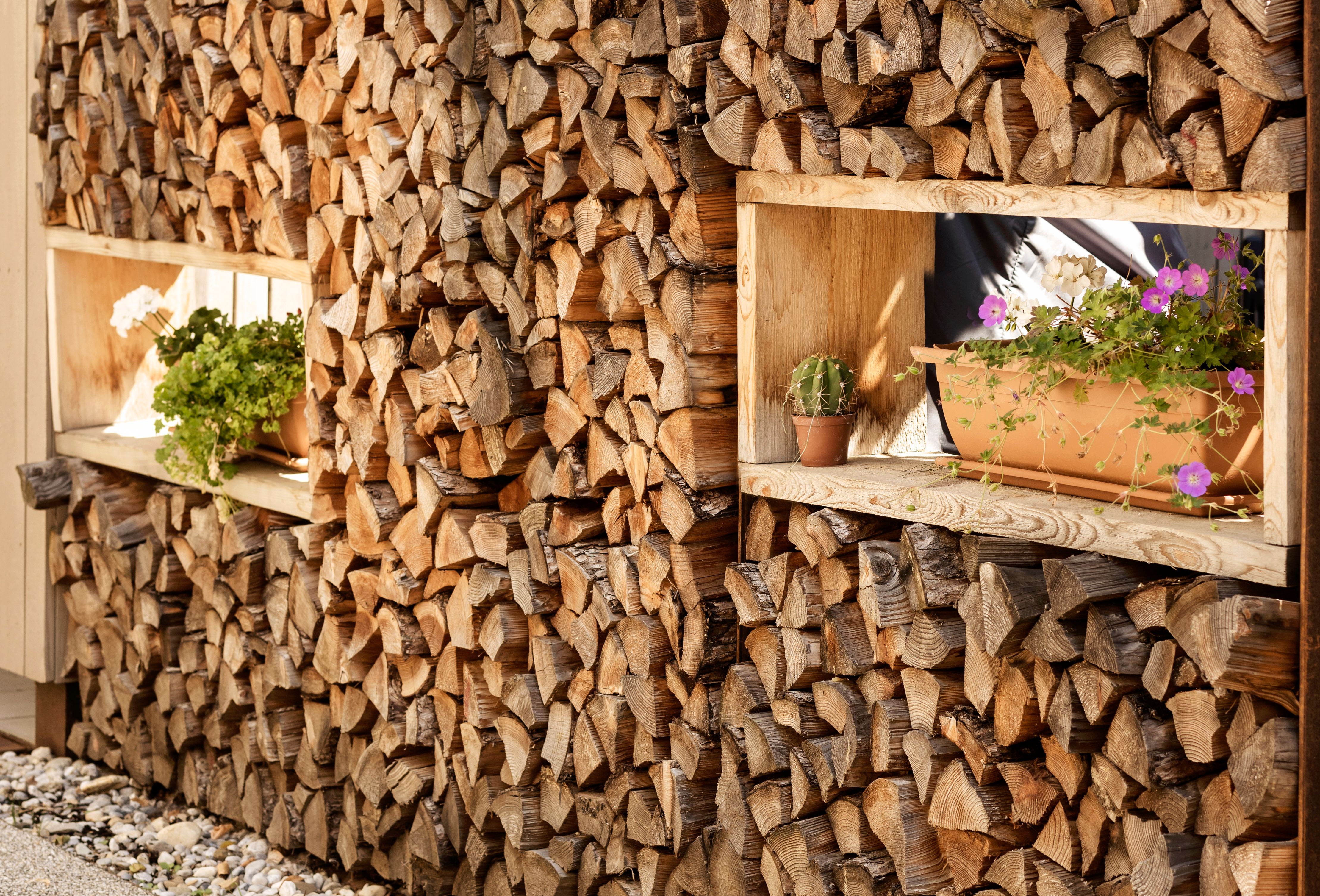 Firewood Storage is decorated with Pots with Flowers