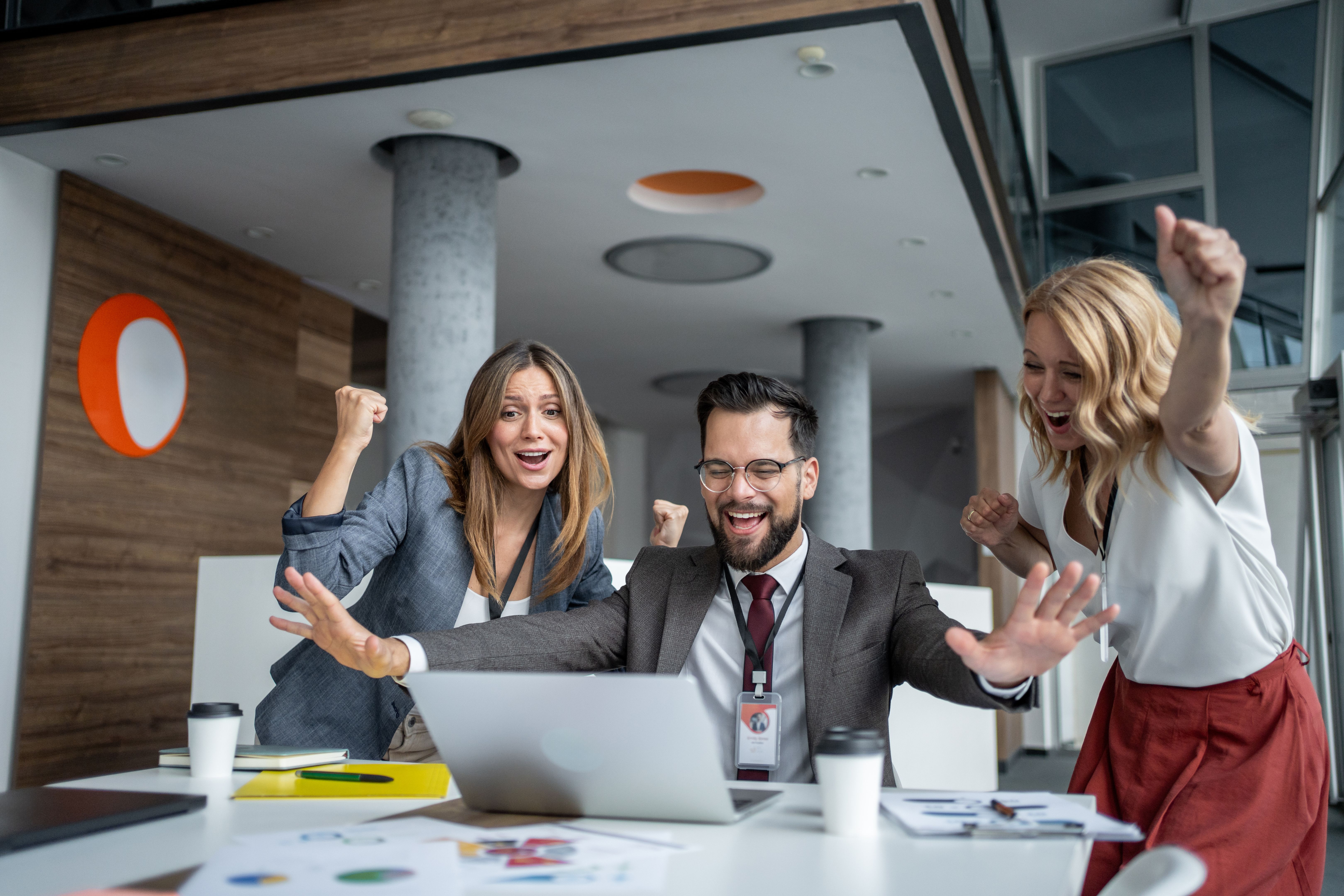 Excited business team celebrating success at work