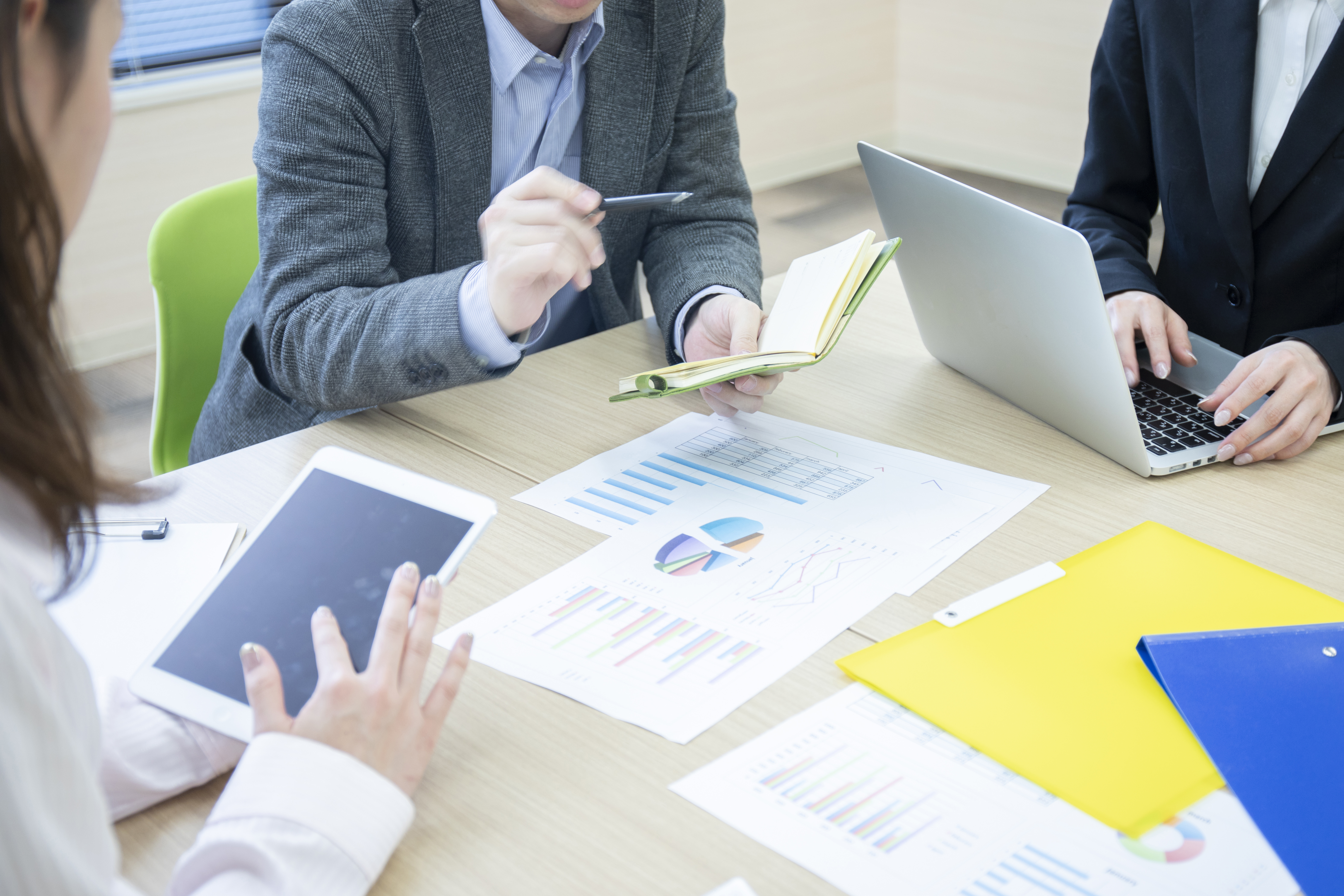 Hands of three men and women meeting in a meeting room