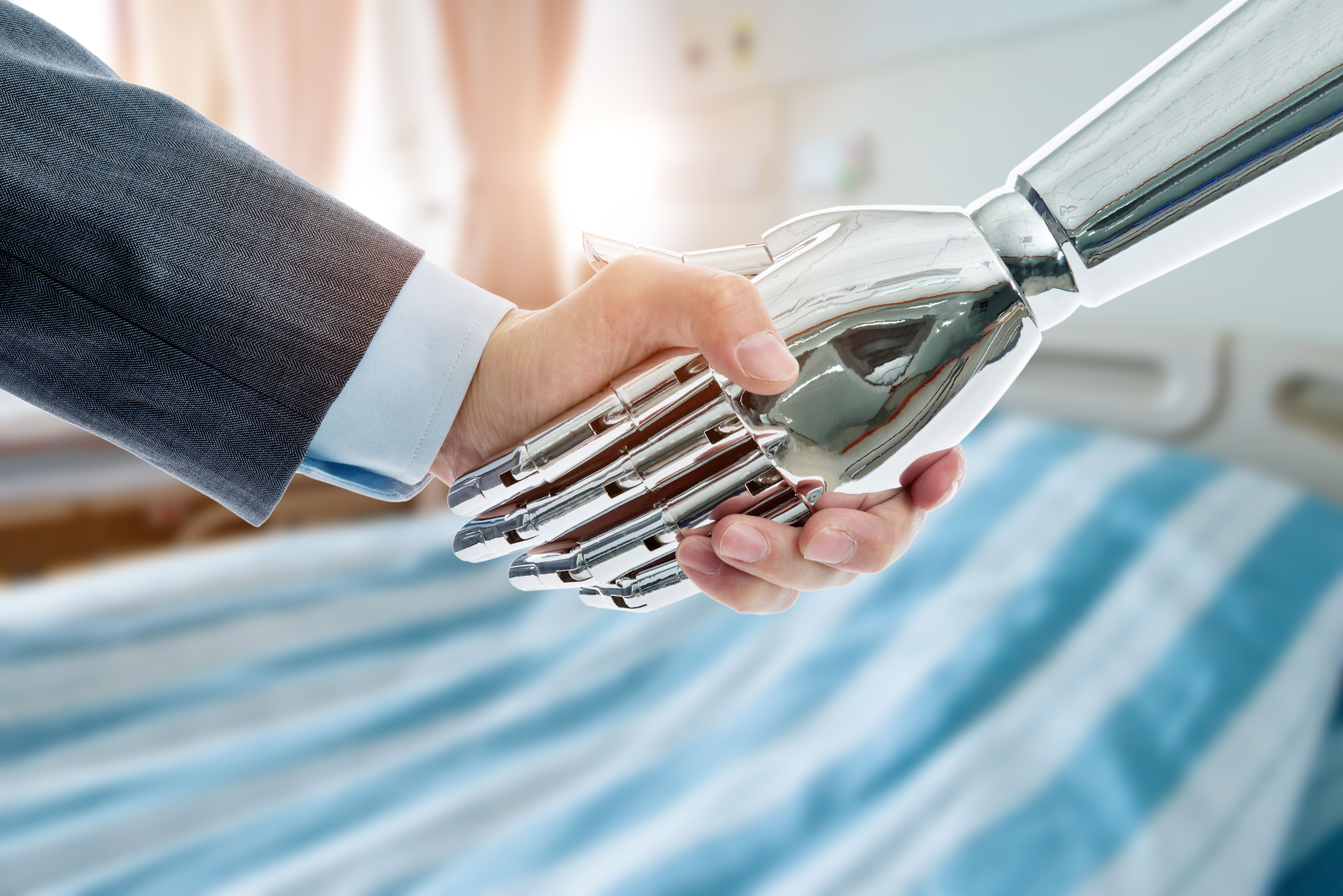 Businessman and robot shaking hands on hospital ward background