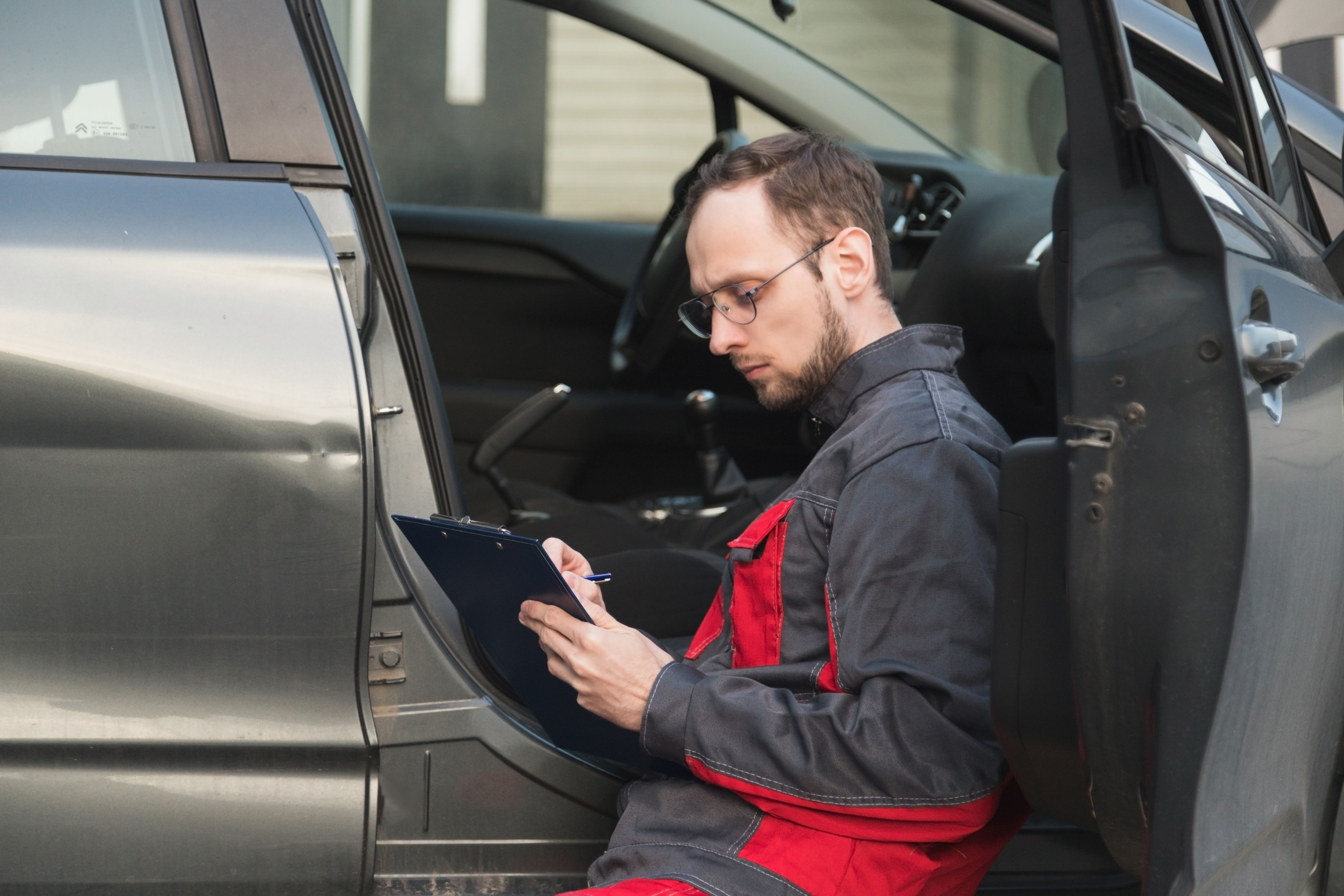 mechanic inspecting car