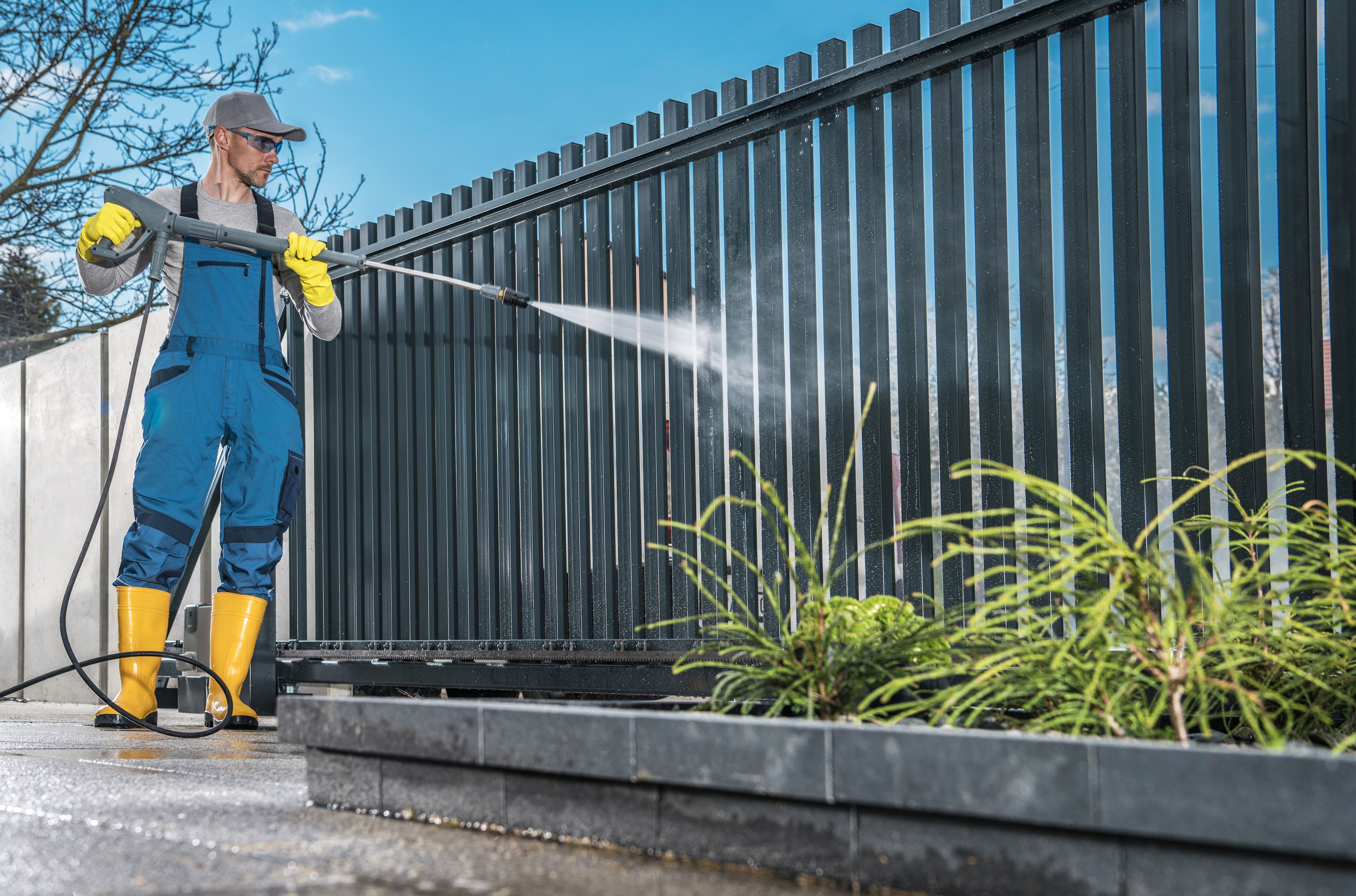 Full Length Of Man Cleaning Gate