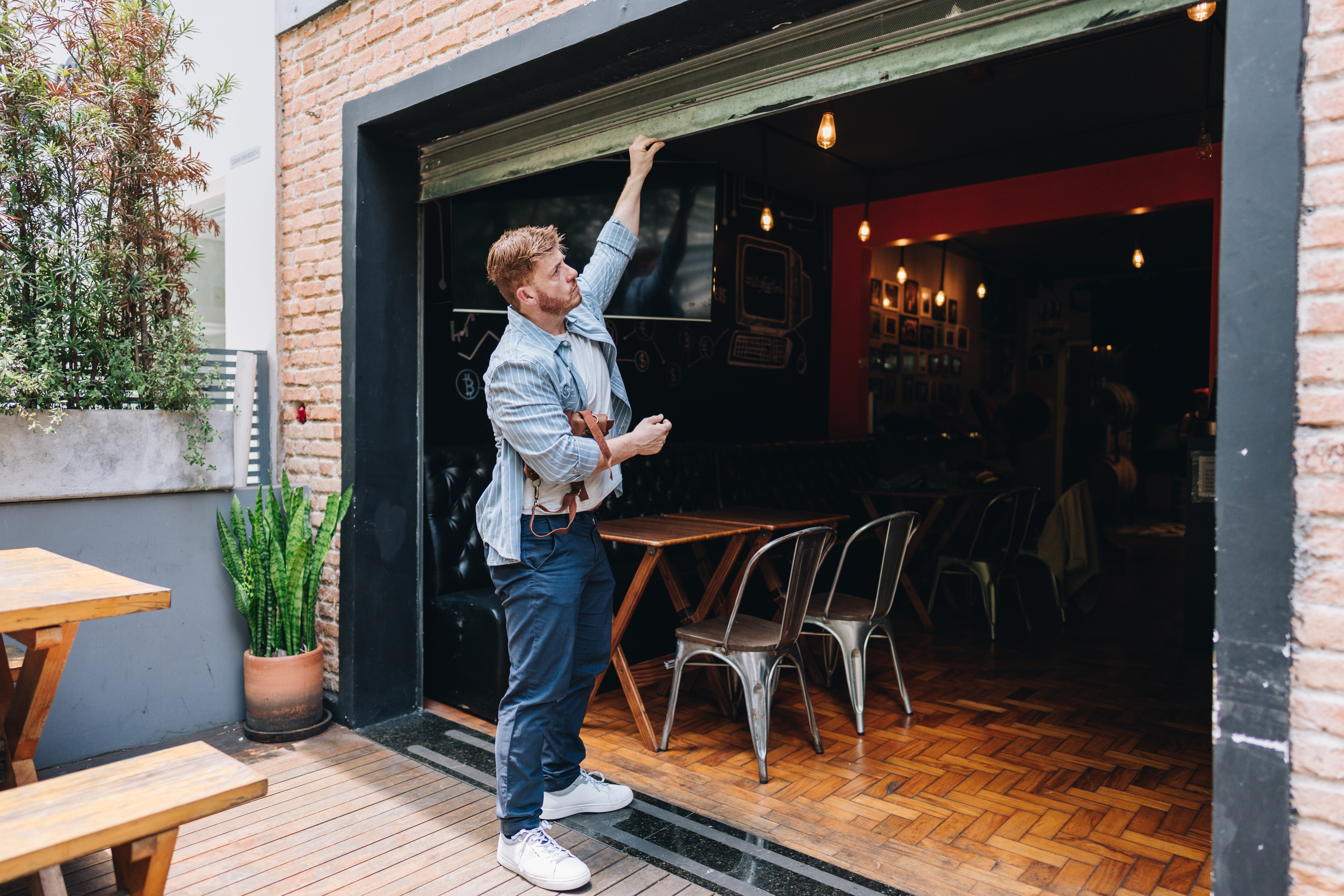 Owner man opening or closing his coffee shop