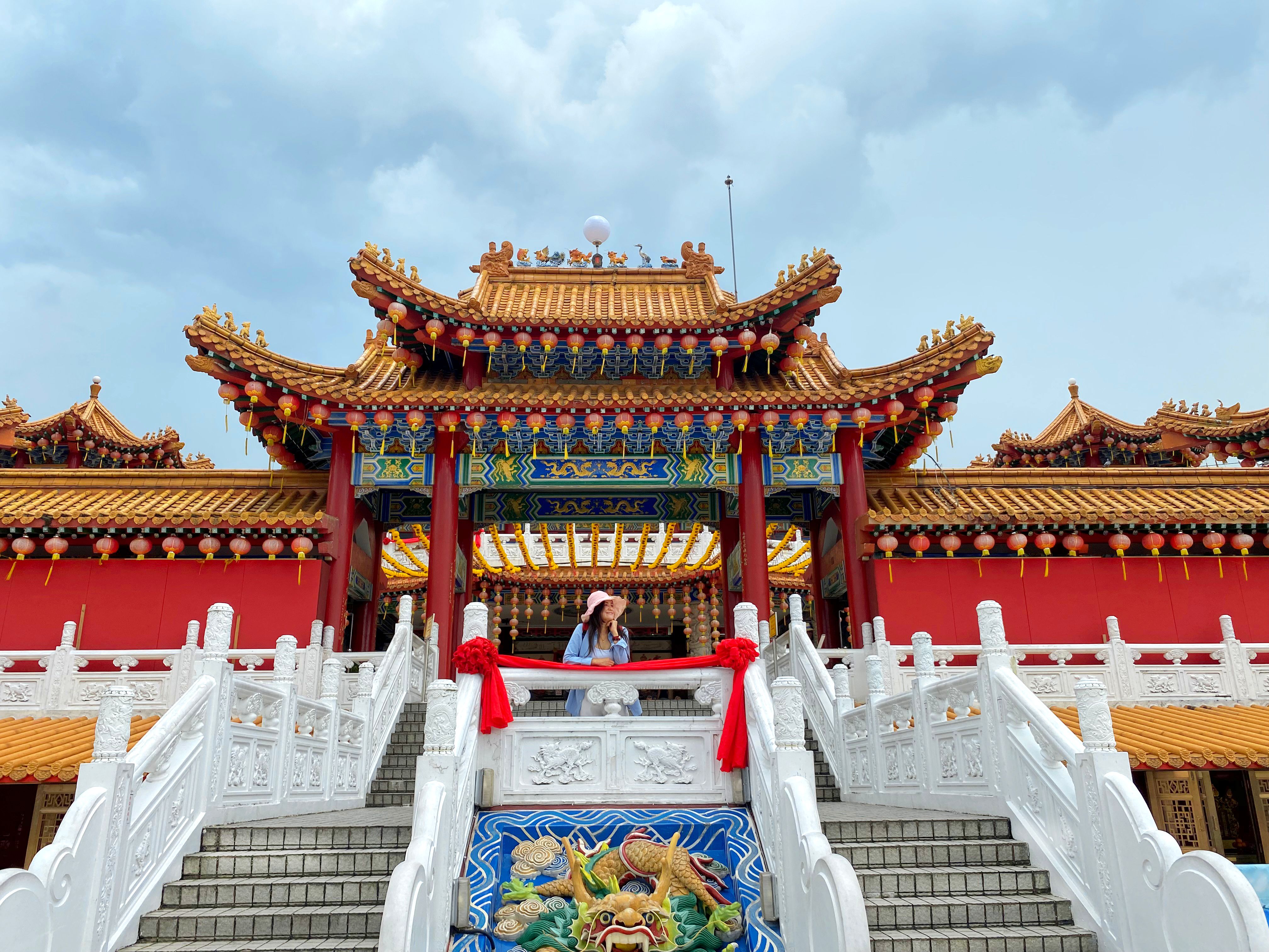 Young asian woman and Chinese temple in Kuala Lumpur