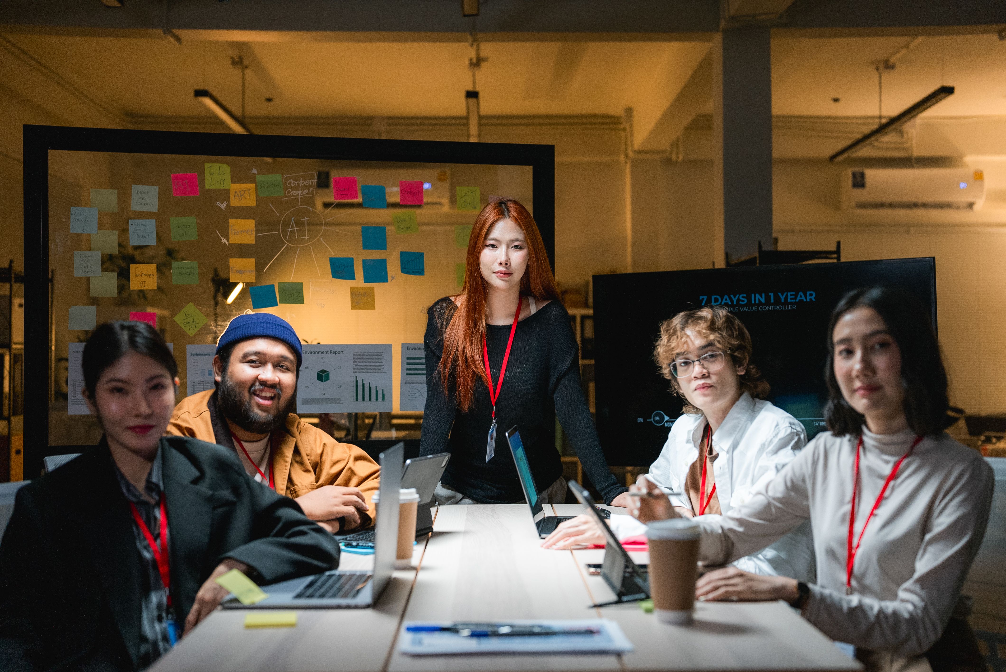 Asian People in a Business meeting are planning their marketing strategy with a glass board.