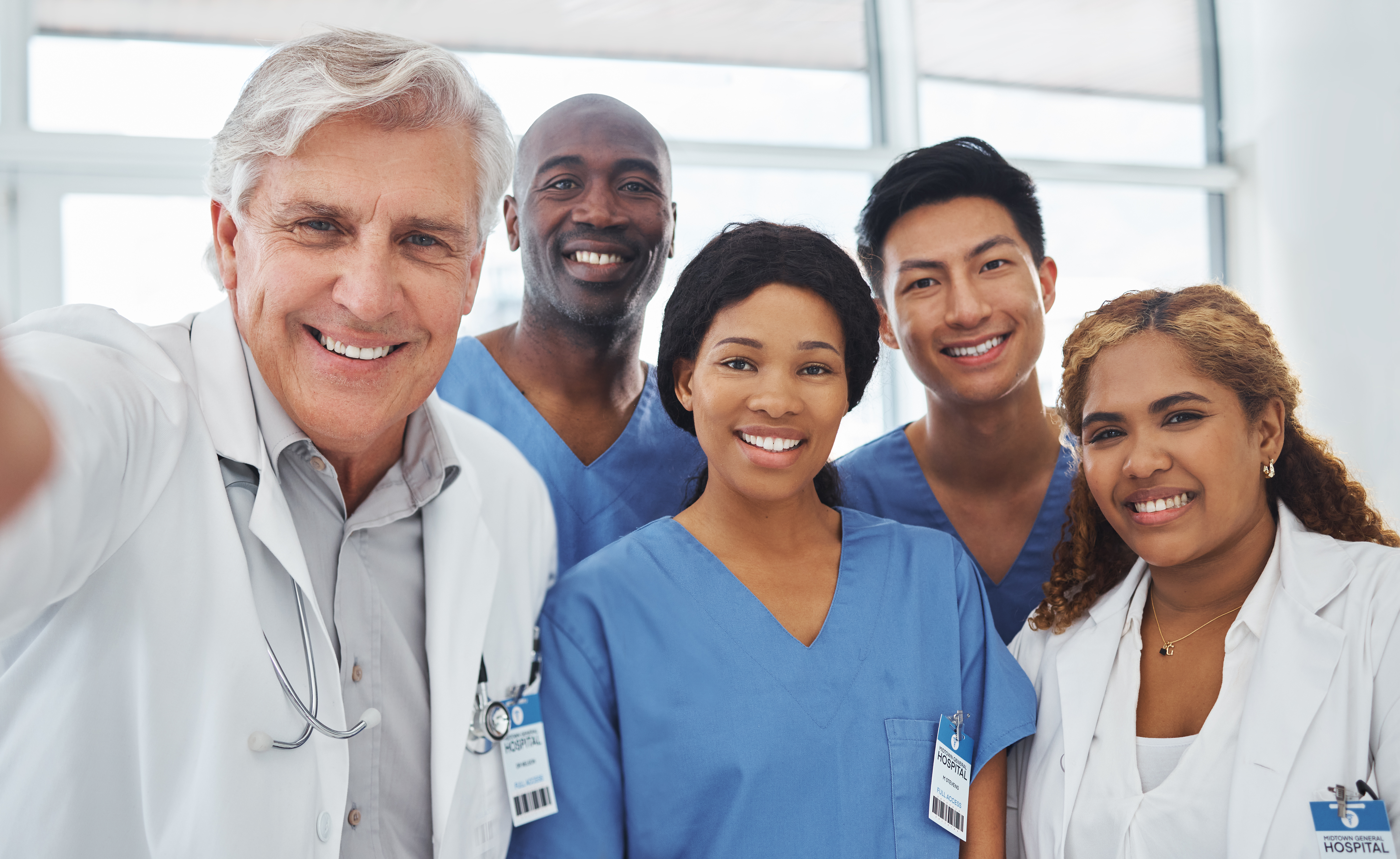 Portrait of a group of medical practitioners taking selfies together in a hospital