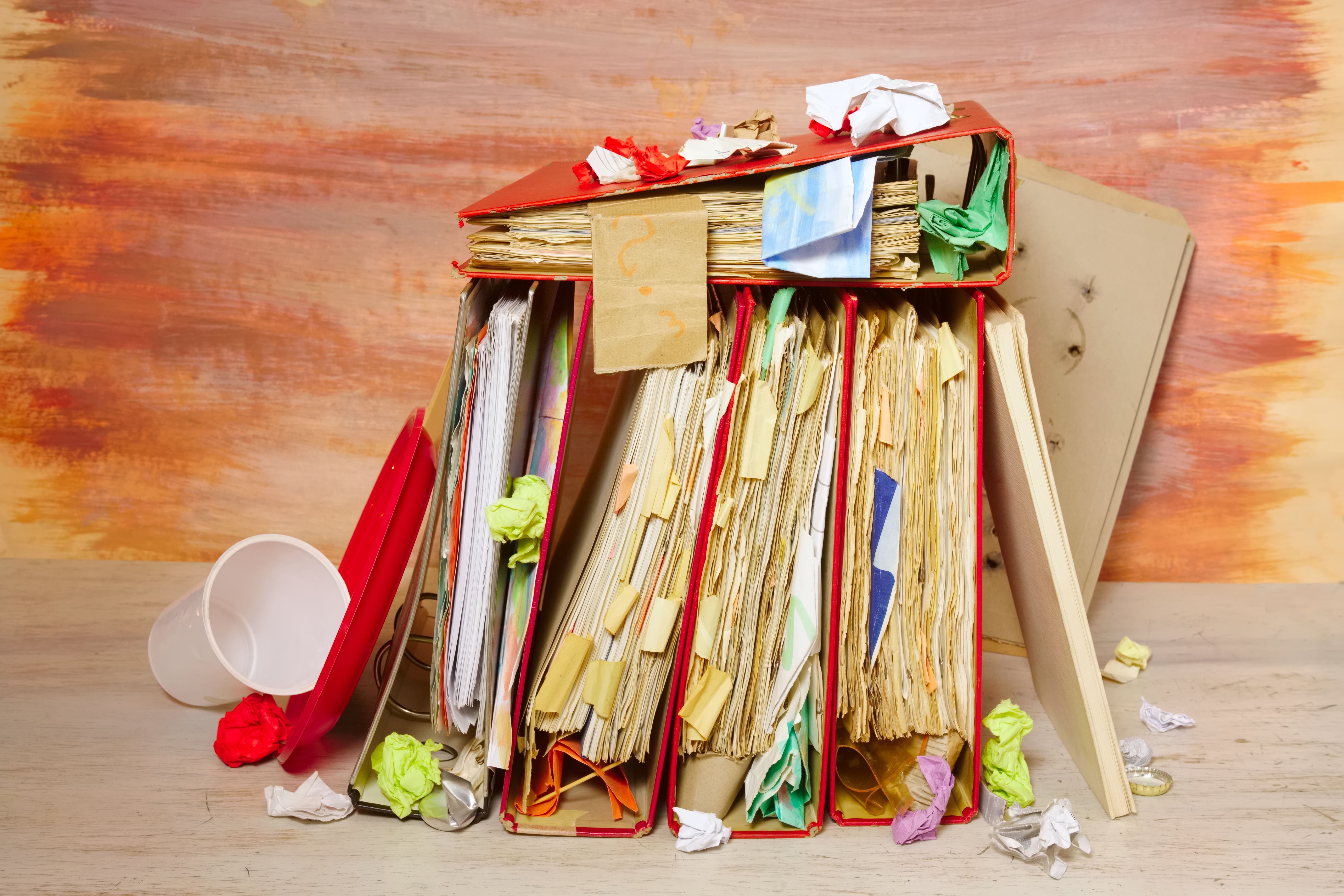 messy file folders and business records ,red tape, bureaucracy,overworked,beat the clock business concept on grungy backgound. messy file folders and business records ,red tape, bureaucracy,overworked,beat the clock business concept on grungy backgound.