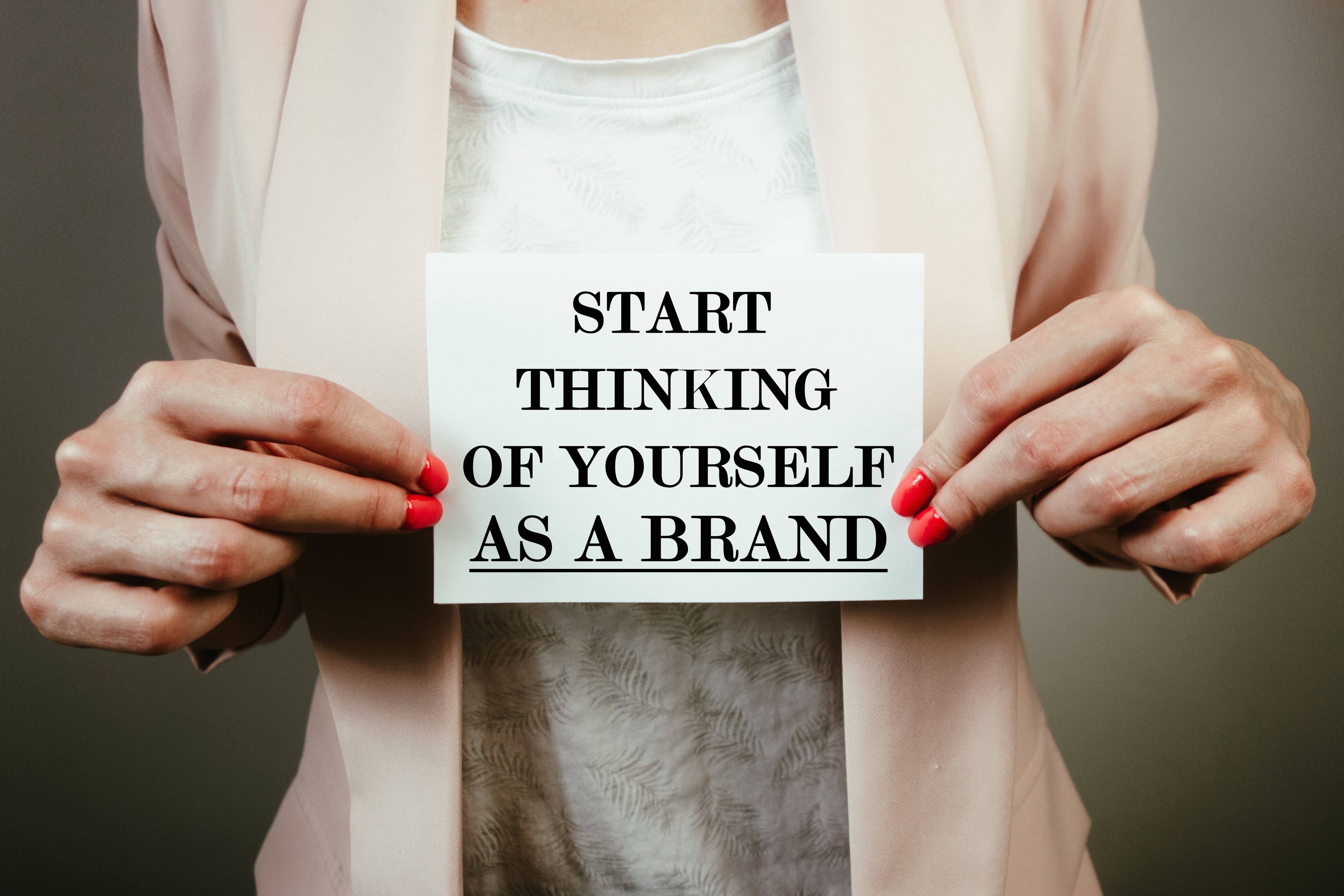 Start thinking of yourself as a brand note in hands of businesswoman. Marketing, branding, business success concept