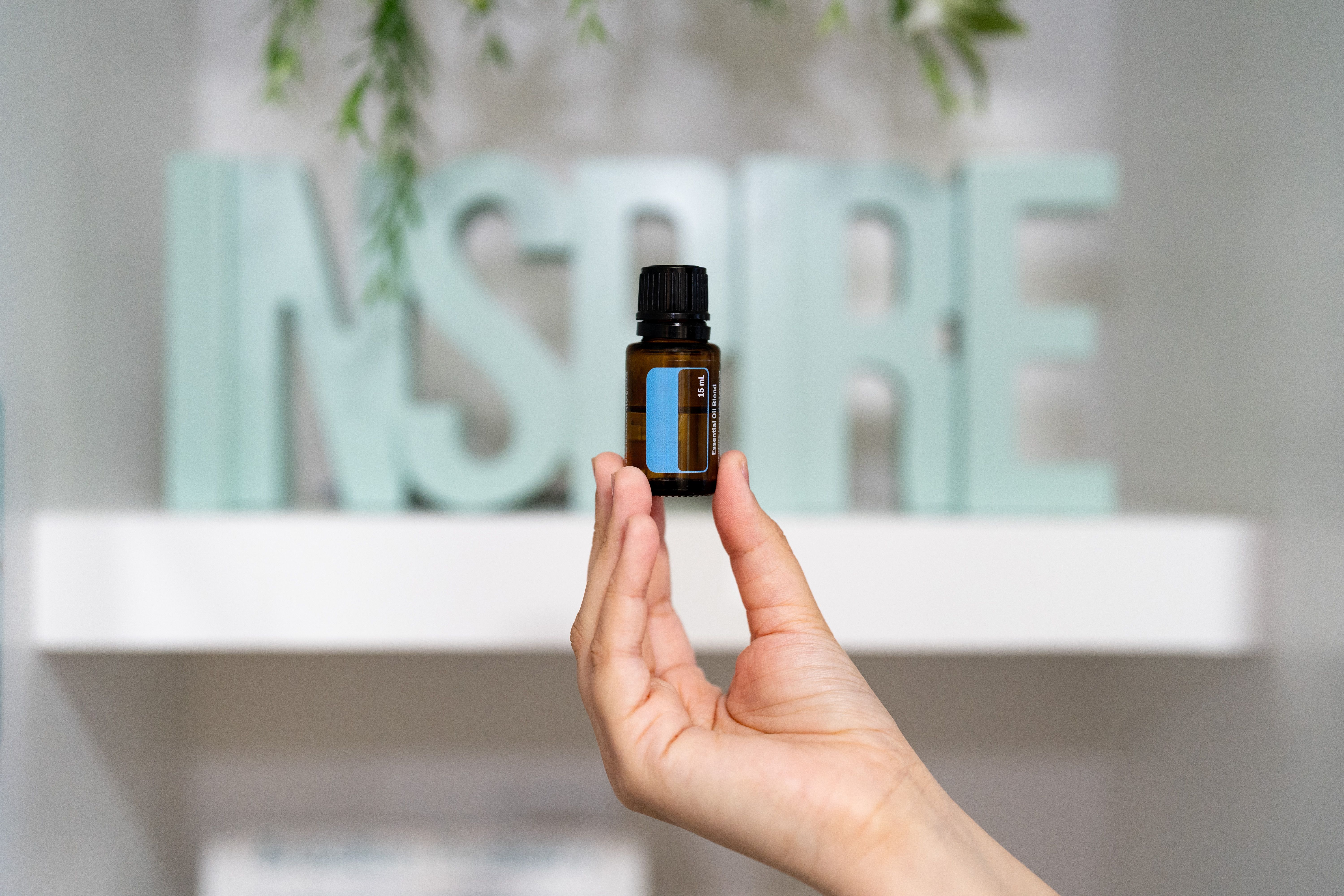 Person holding an essential oil bottle