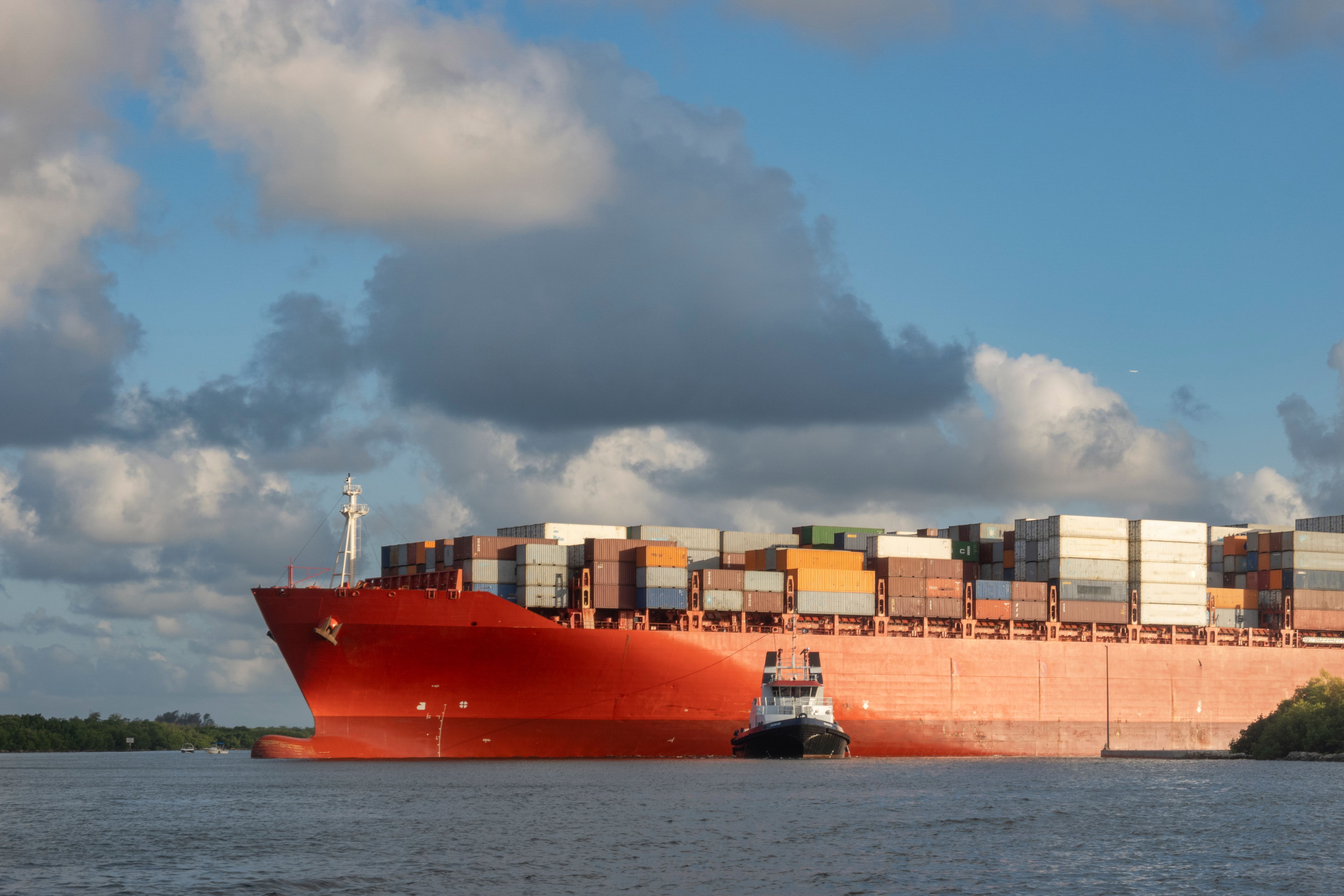 Cargo ship with containers departing from the seaport