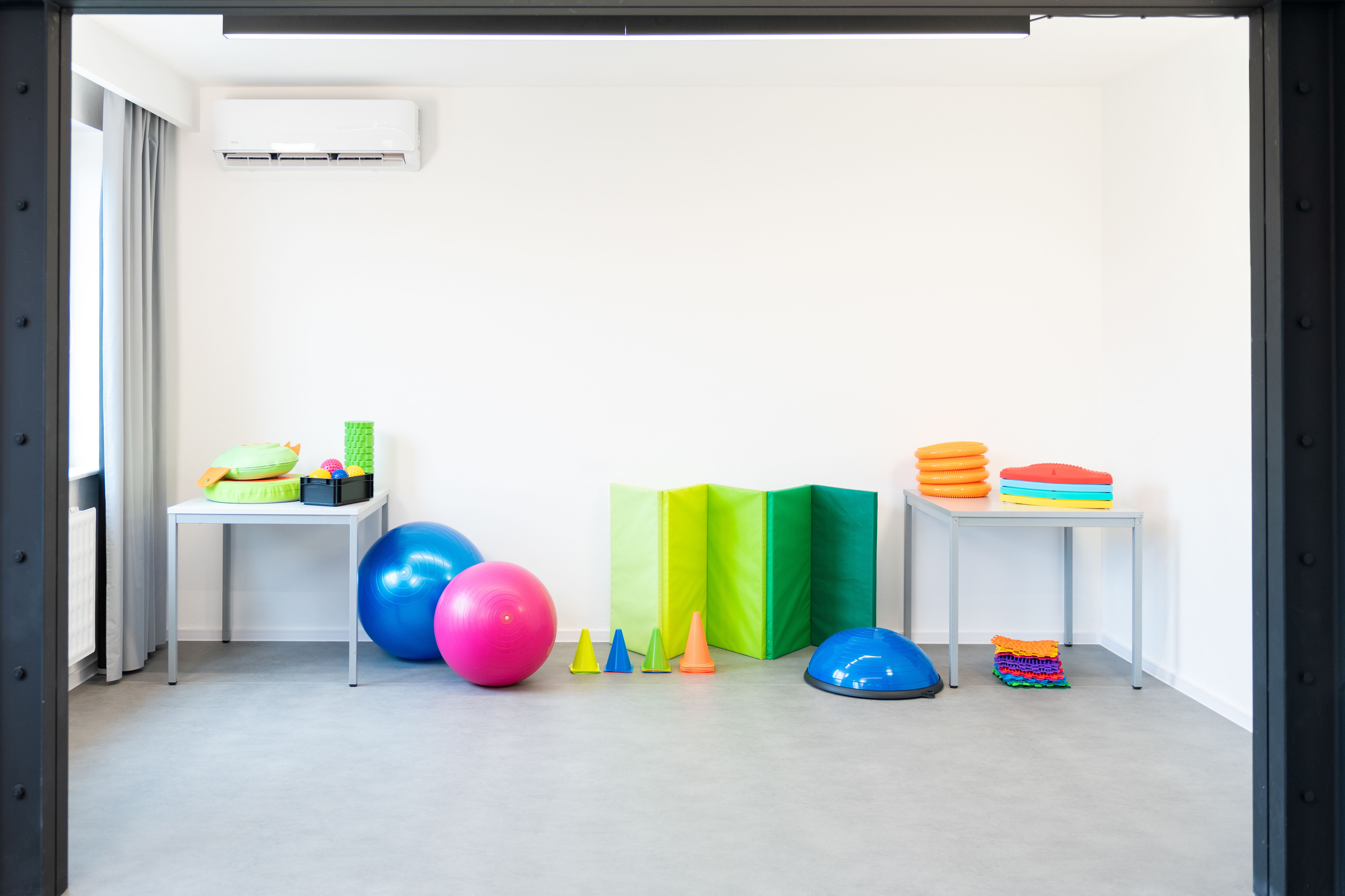 Colorful equipment used in child physical therapy sessions. Physiotherapy room filled with tools. Colorful equipment used in child physical therapy sessions. Physiotherapy room filled with tools.
