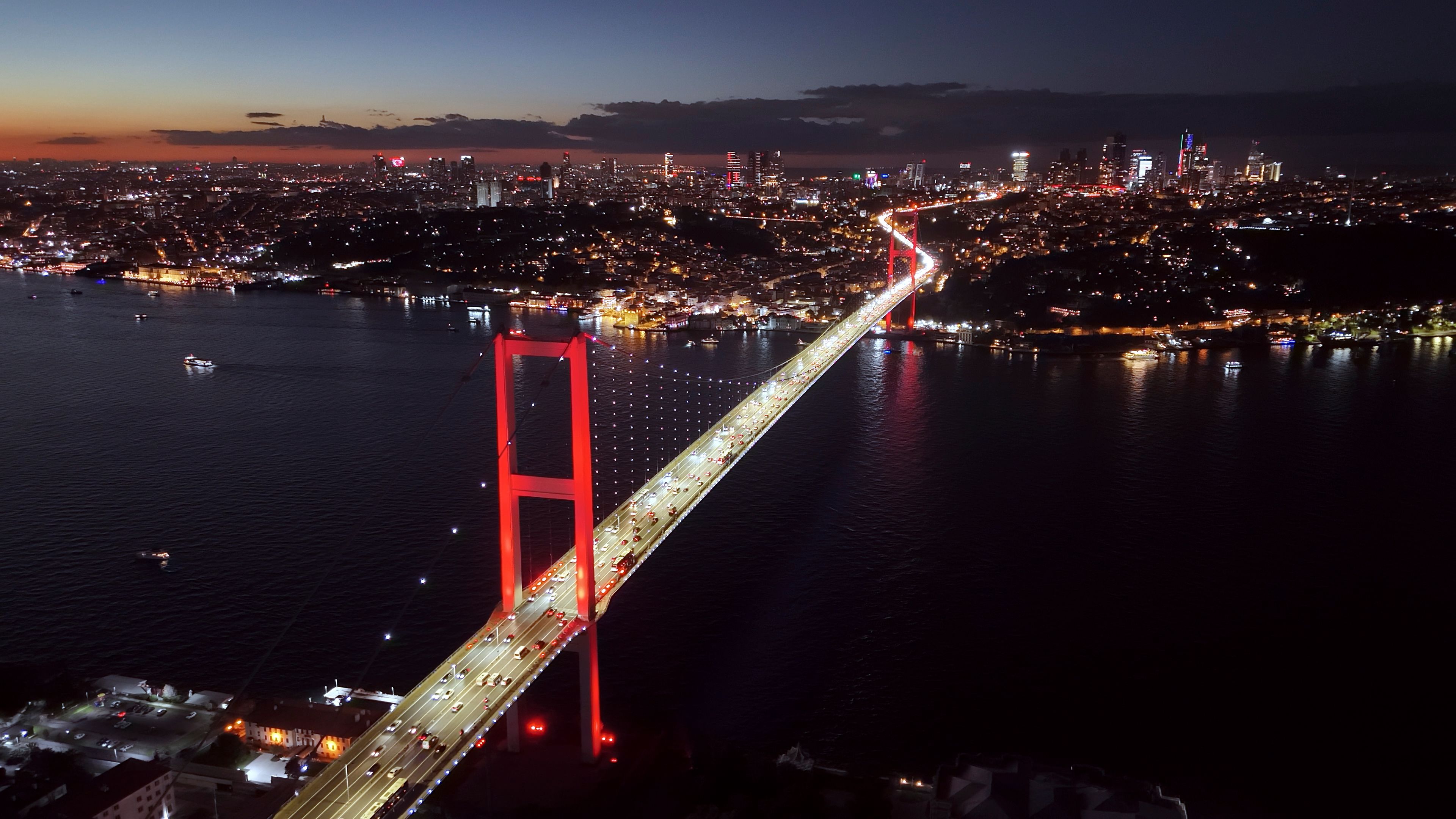Aerial View of Illuminated Cityscape and Bosphorus Bridge against Cloudy Sky during Night at Istanbul,Turkey