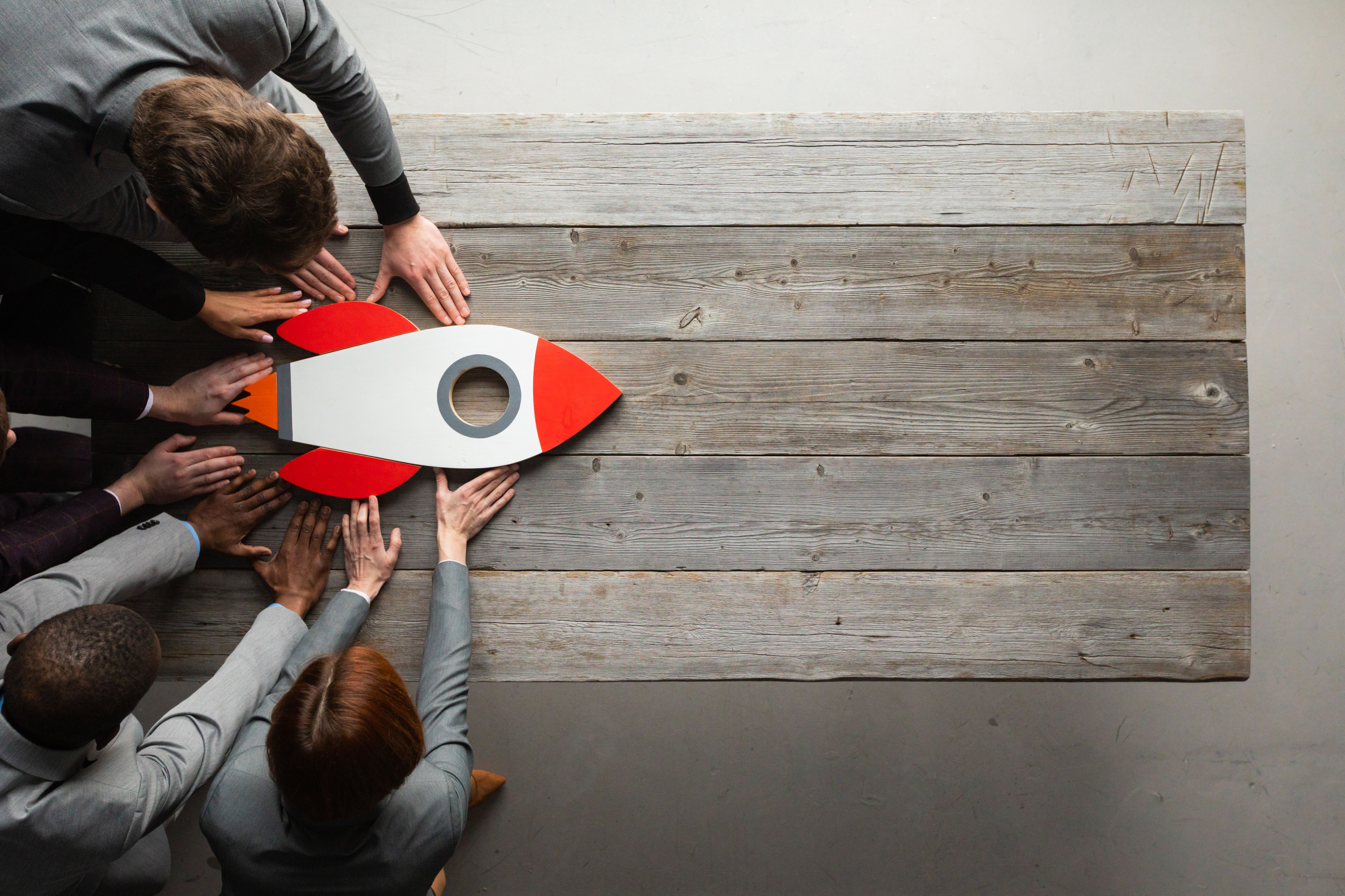Creative team with startup rocket