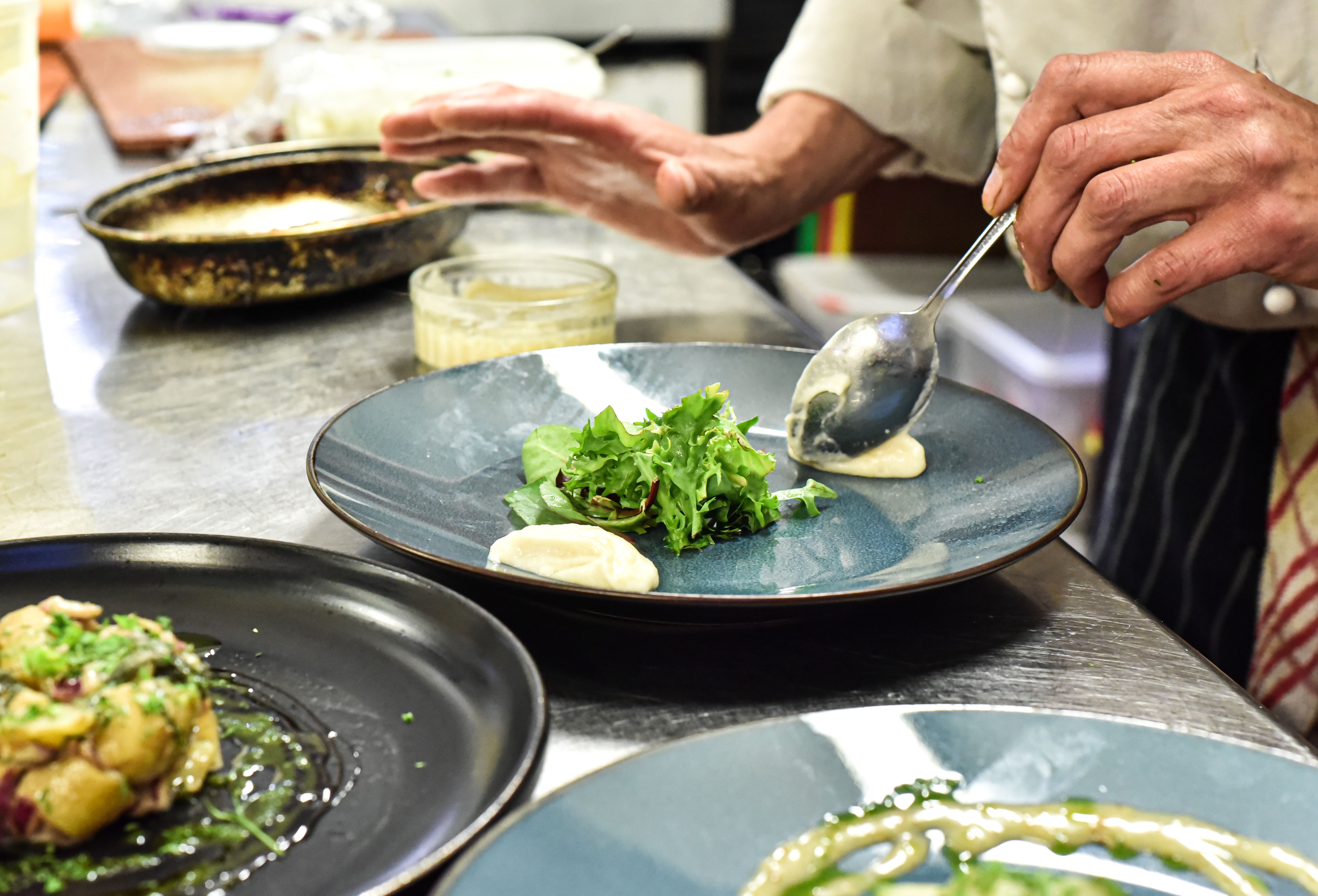 a chef in a kitchen preparing food on the counter in front of the camera a chef in a kitchen preparing food on the counter in front of the camera