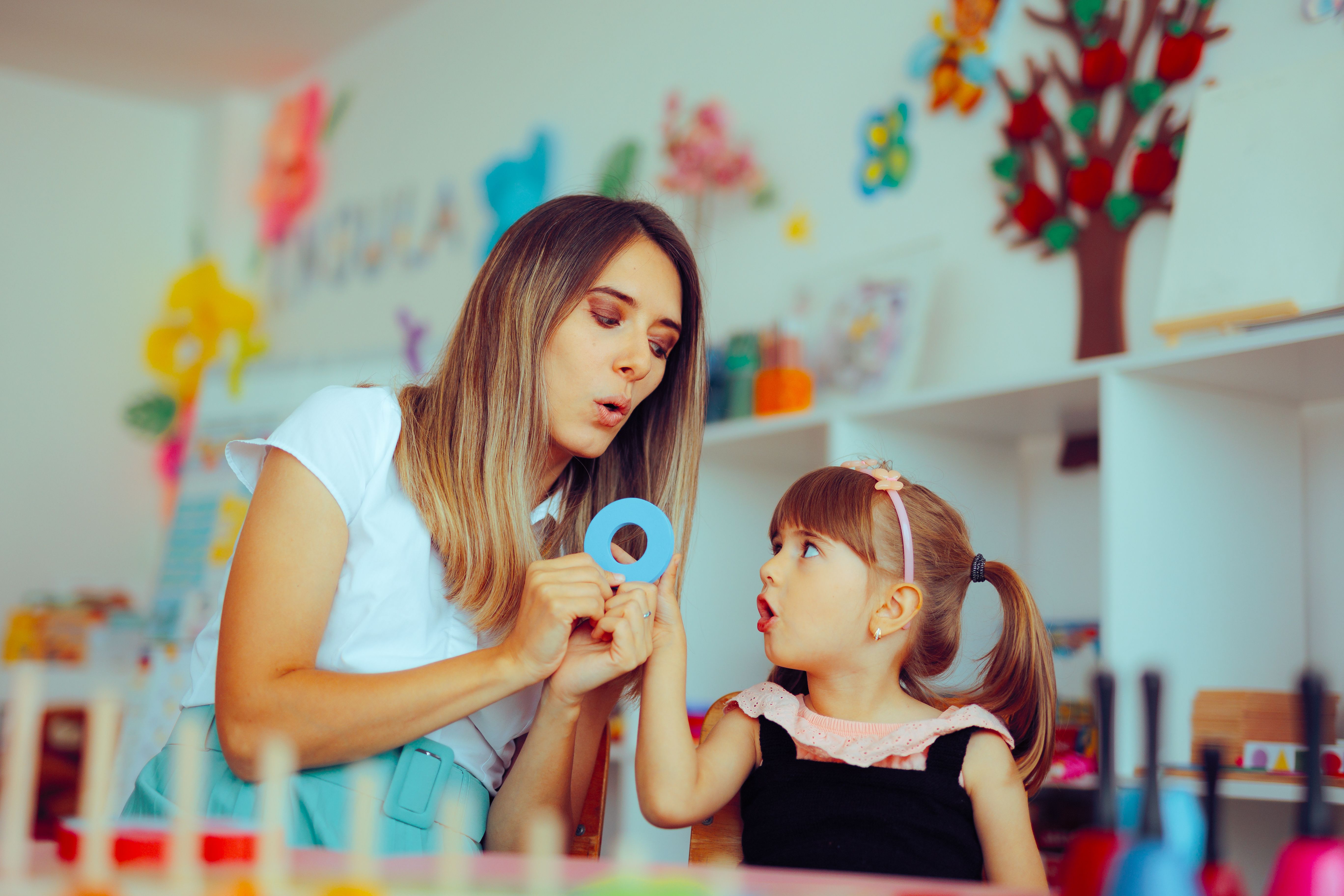 Speech Therapist Teaching a Child the Correct Pronunciation
