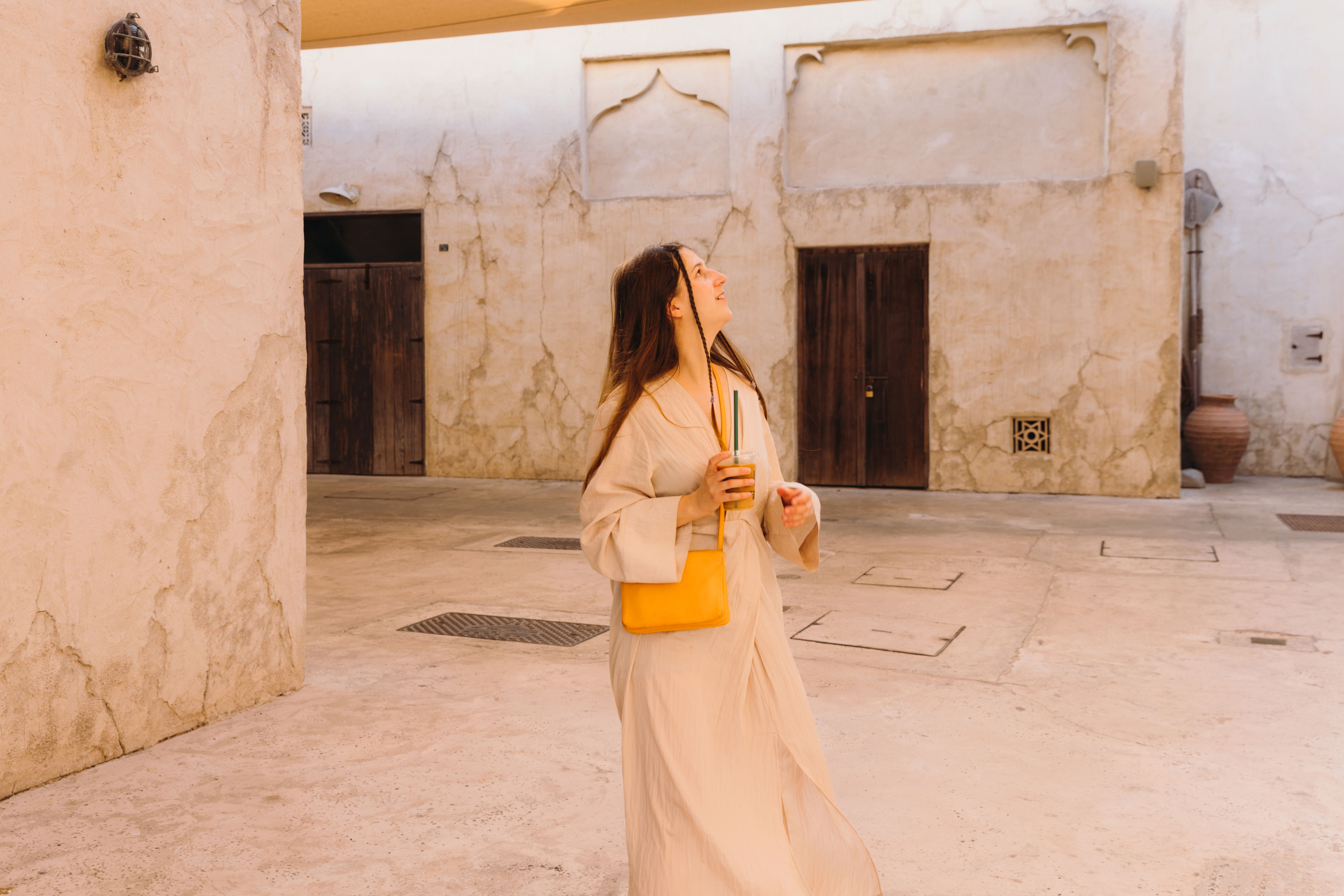 Handsome Woman With Coffee Walking at Old Town of Dubai City