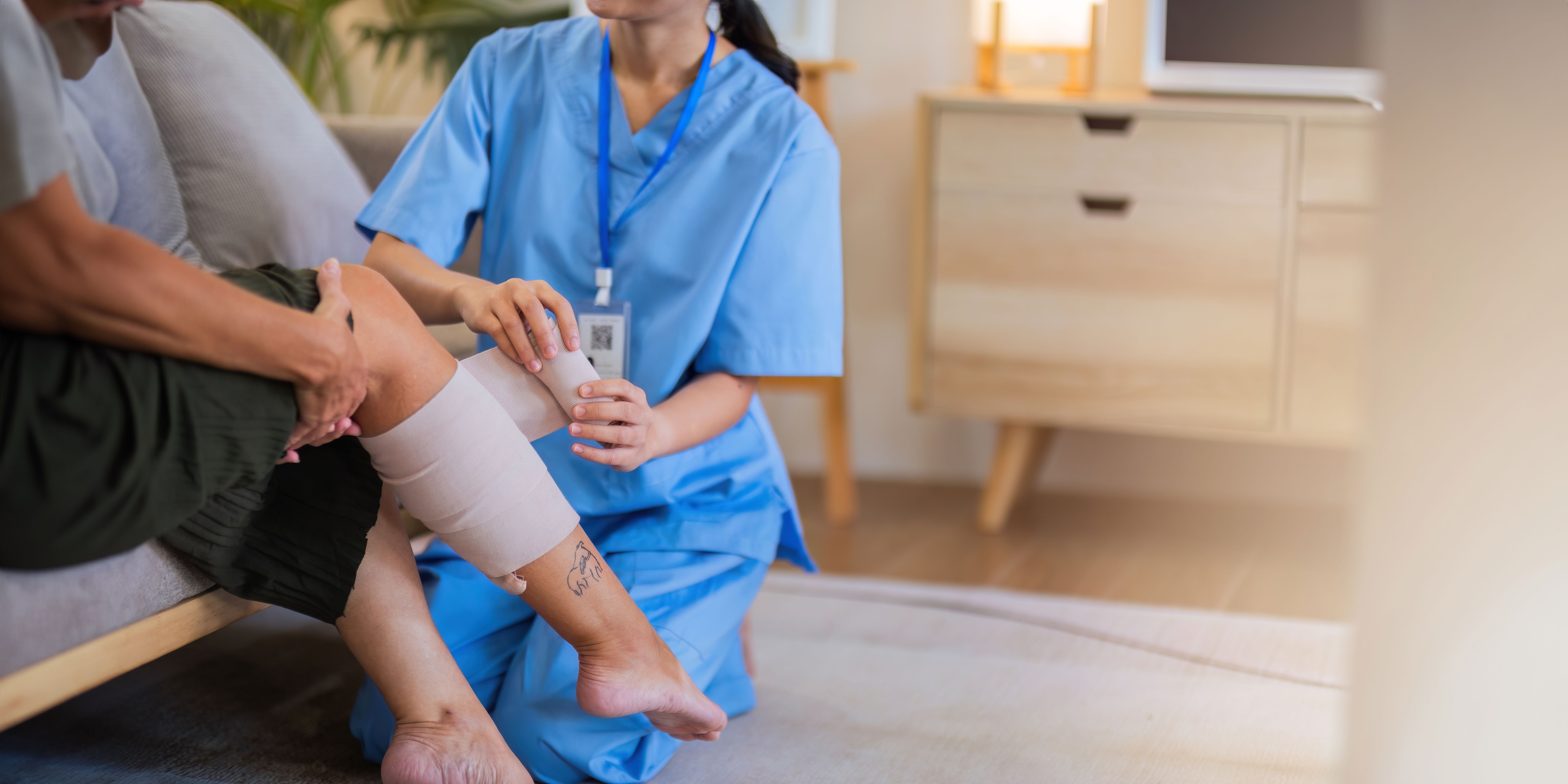 Physical therapist caregiver Asian and Caucasian senior women trust moving hand in rehabilitation. Physiotherapy healthcare, Medical caregiver consulting disabled elderly patient at home