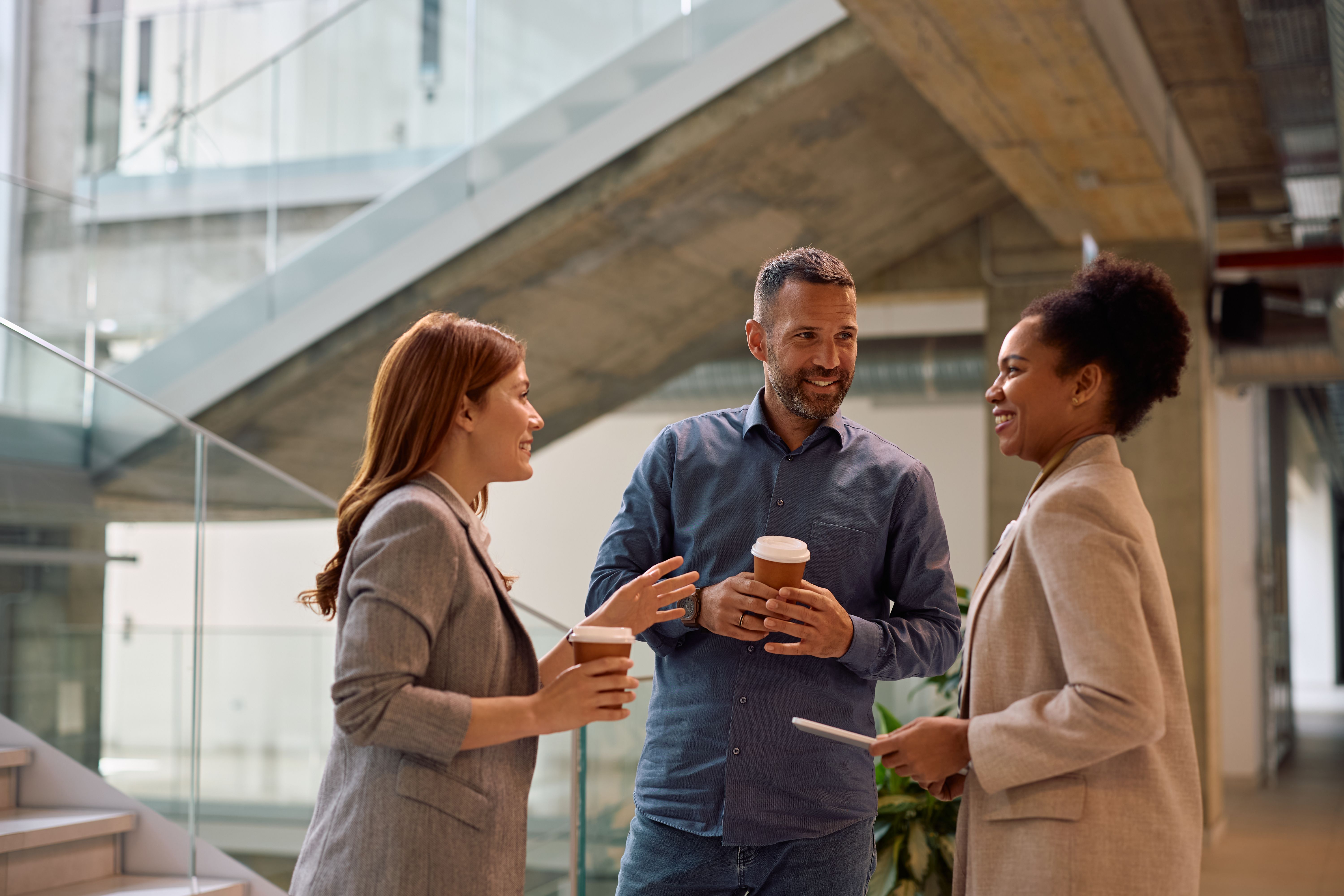 Multiracial group of business coworkers having a coffee break in the office.
