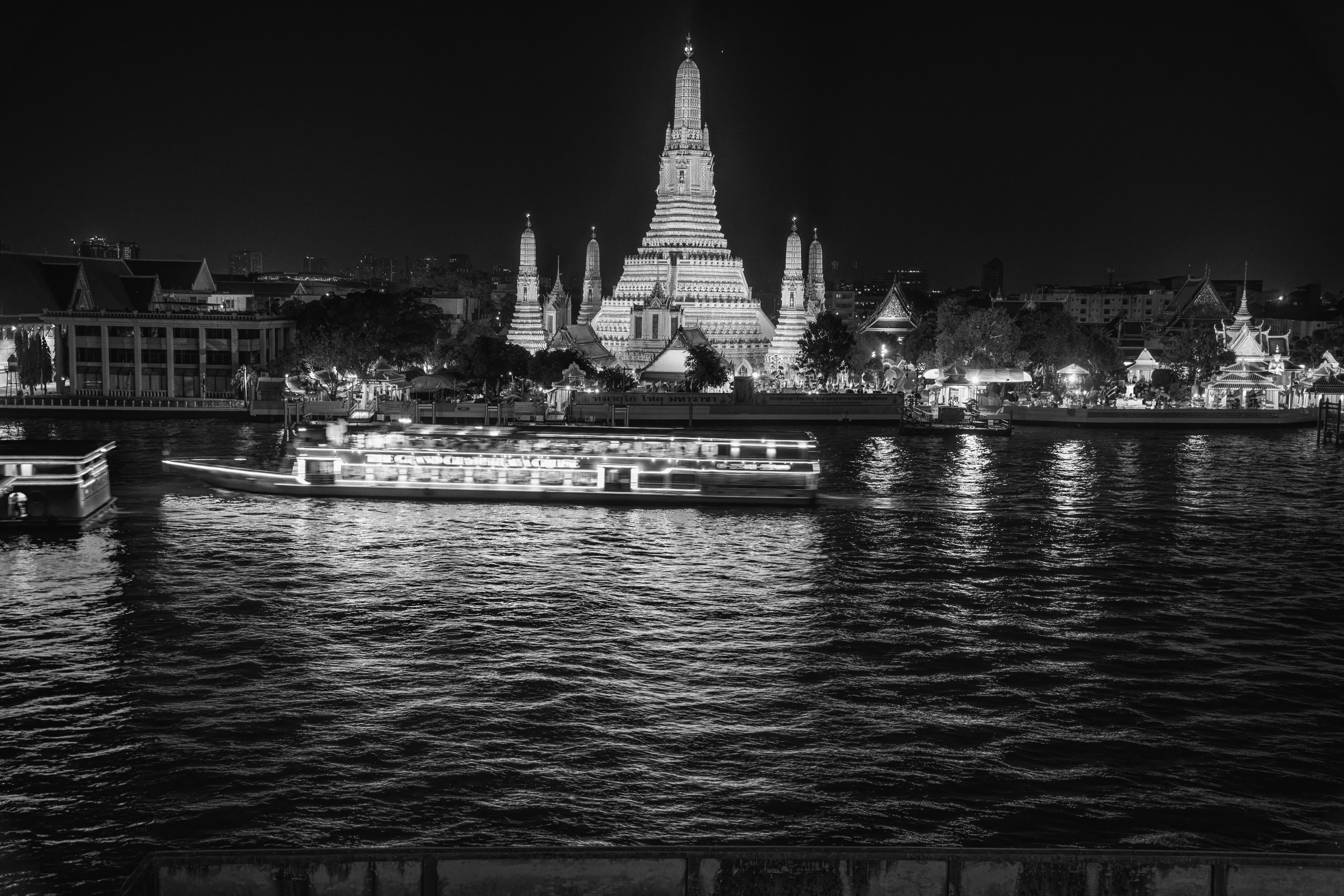 Wat Arun temple beautifully illuminated at night along the Chao Phraya River in Bangkok, Thailand Wat Arun temple beautifully illuminated at night along the Chao Phraya River in Bangkok, Thailand