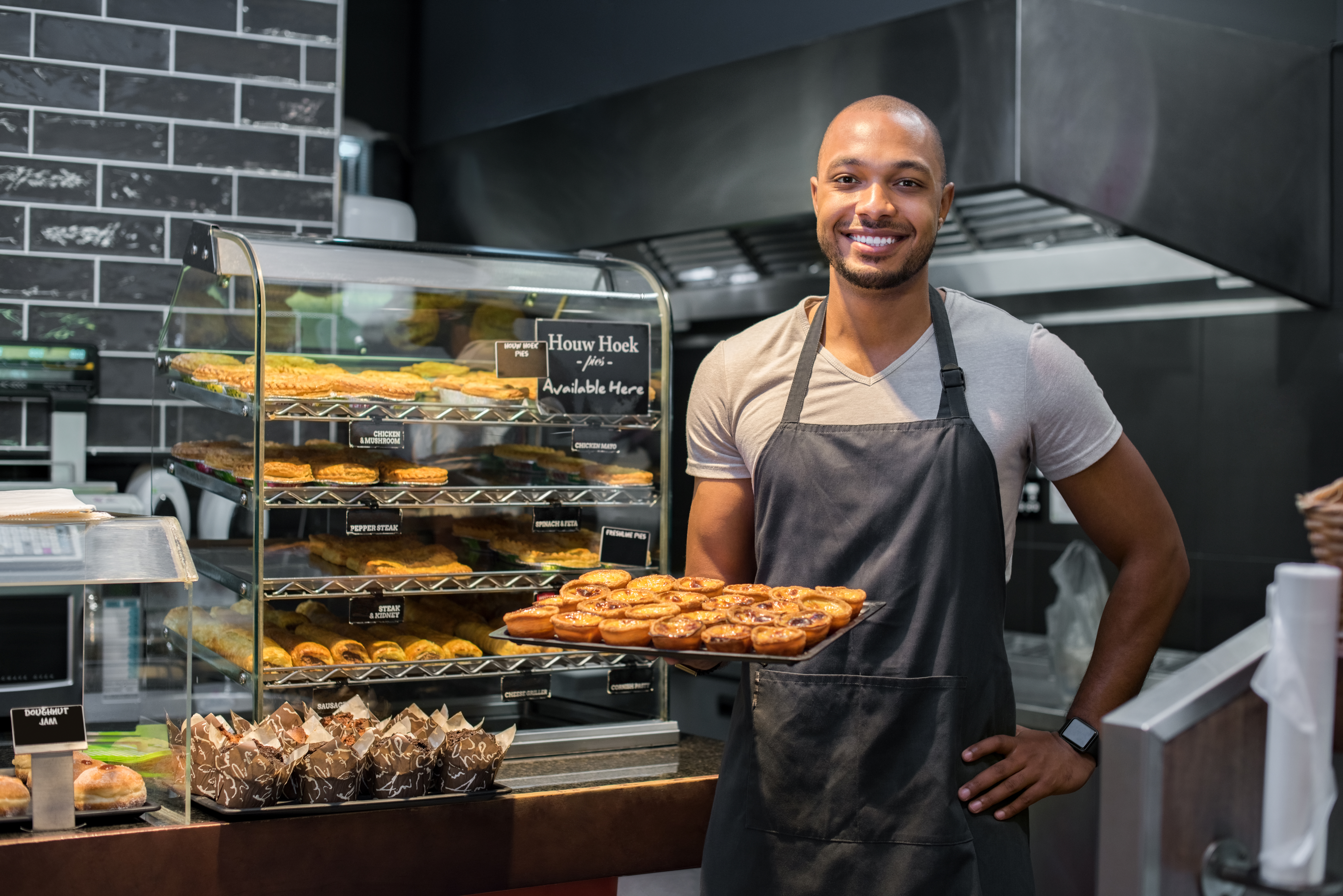 Pastry chef holding small pastry