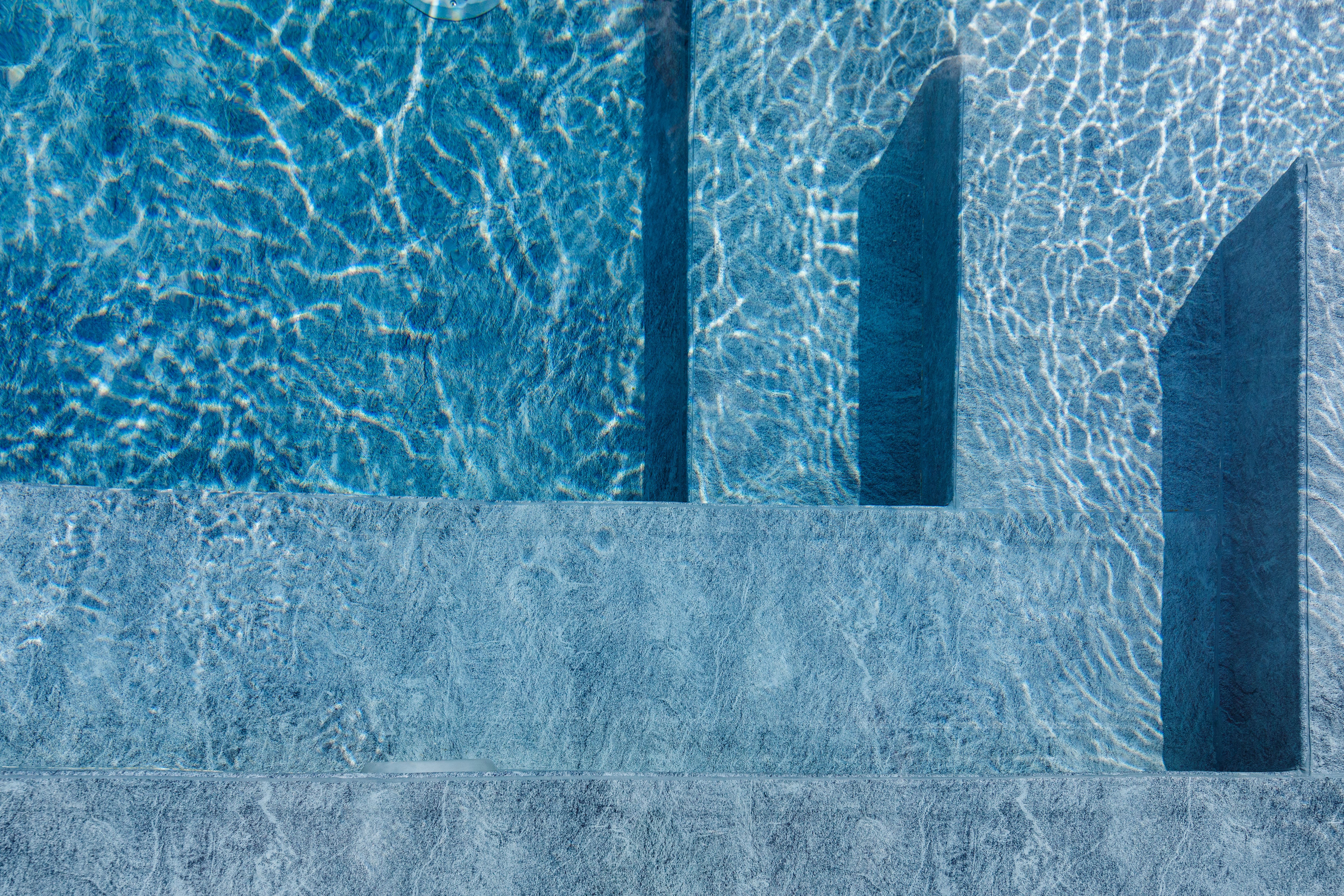Blue water background. Swimming Pool. Pool edge.