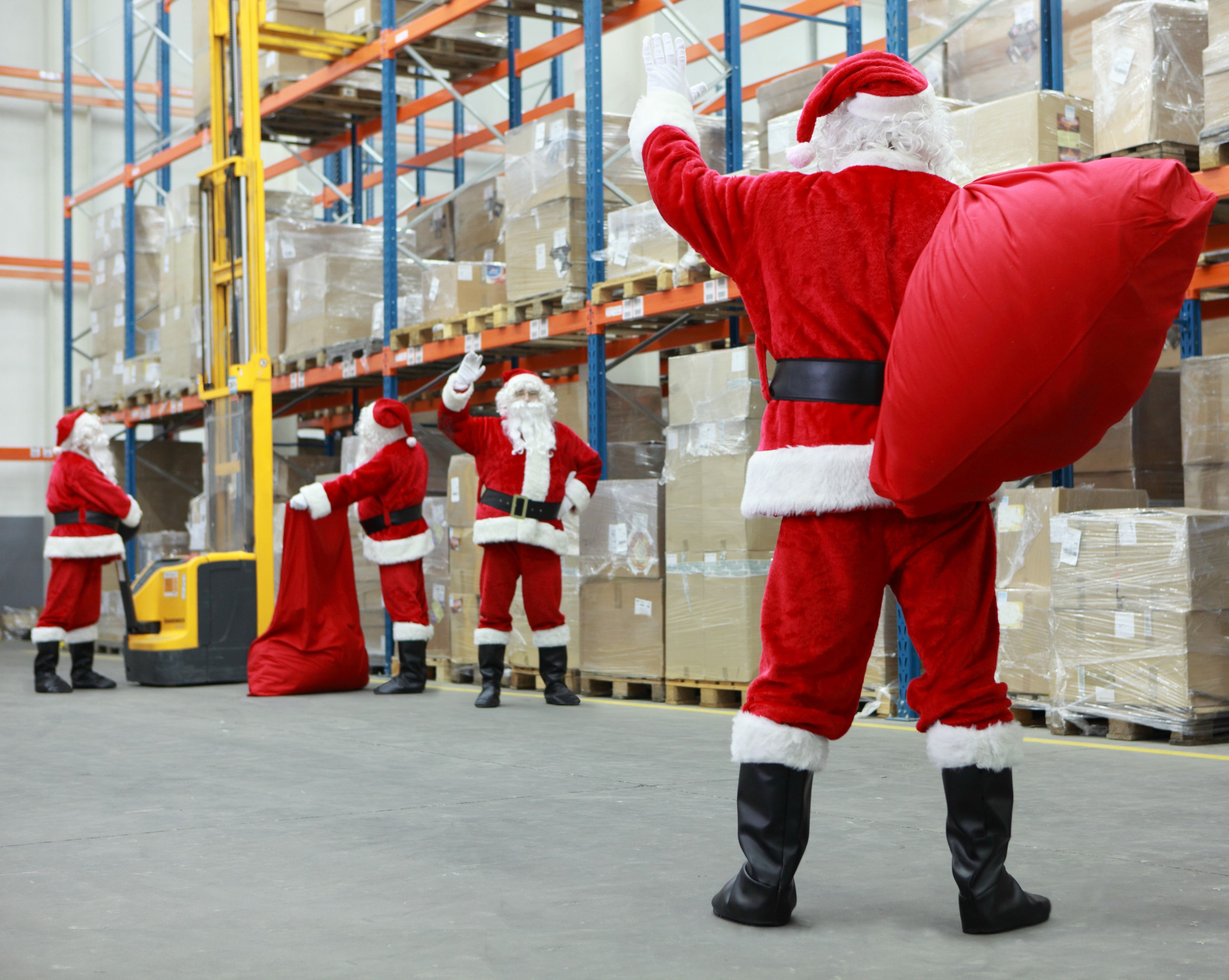 Santas at a warehouse working for Christmas