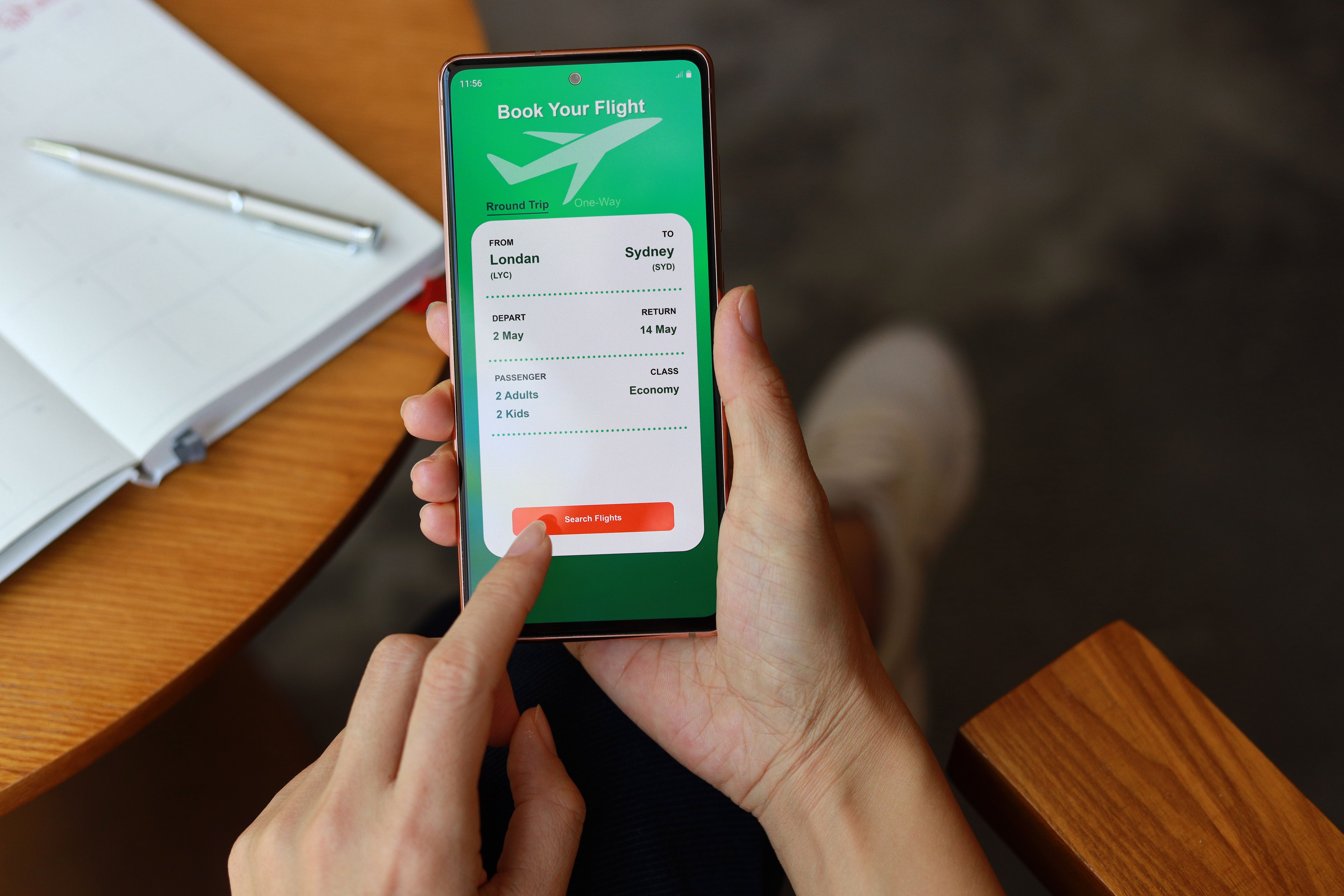 Woman using smartphone to book flight tickets and plan holiday Woman using smartphone to book flight tickets and plan holiday