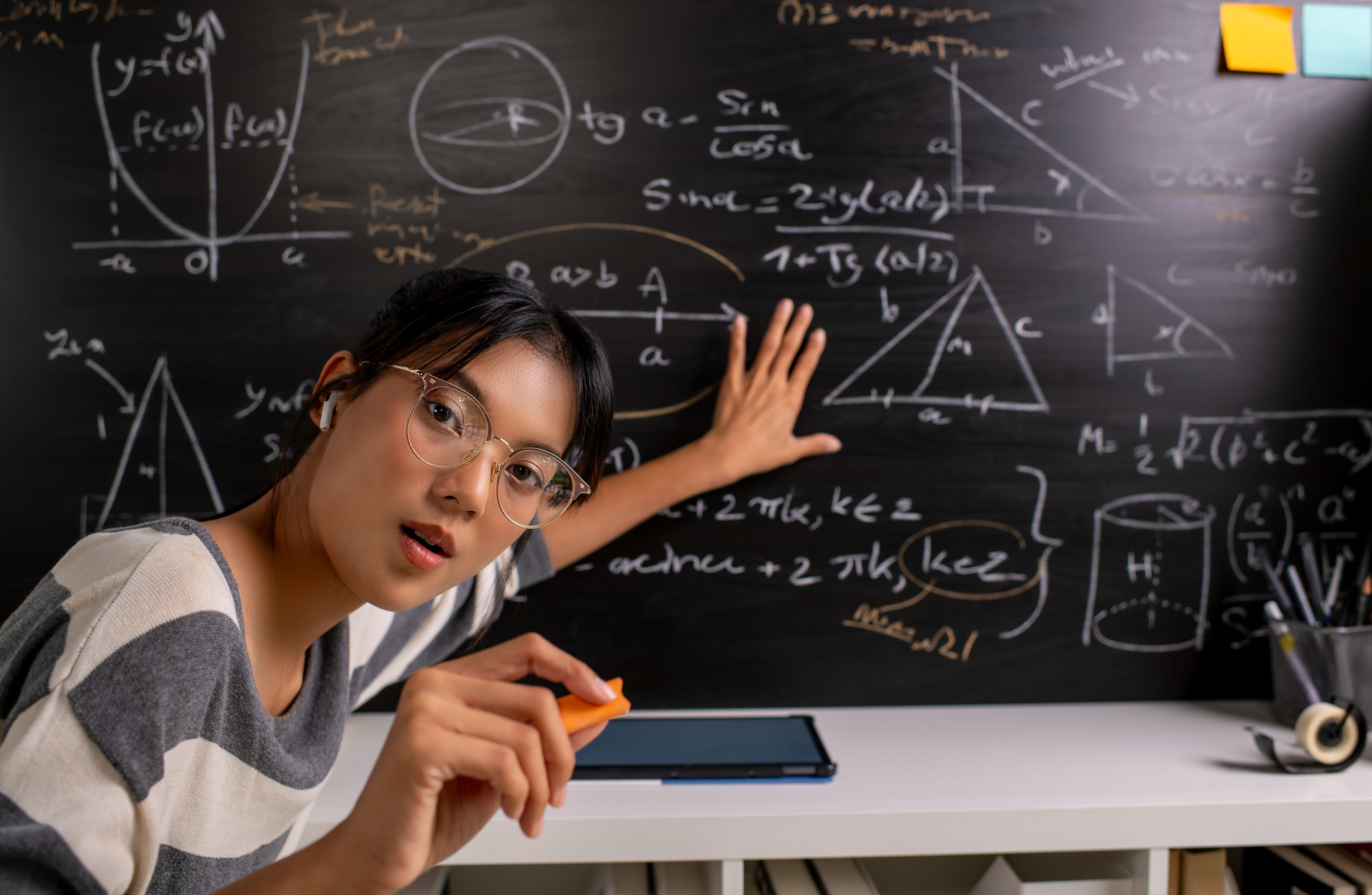 Young Asian teacher transforms her living space into an engaging online classroom,  teaching online with passion, concept of online teaching and education.