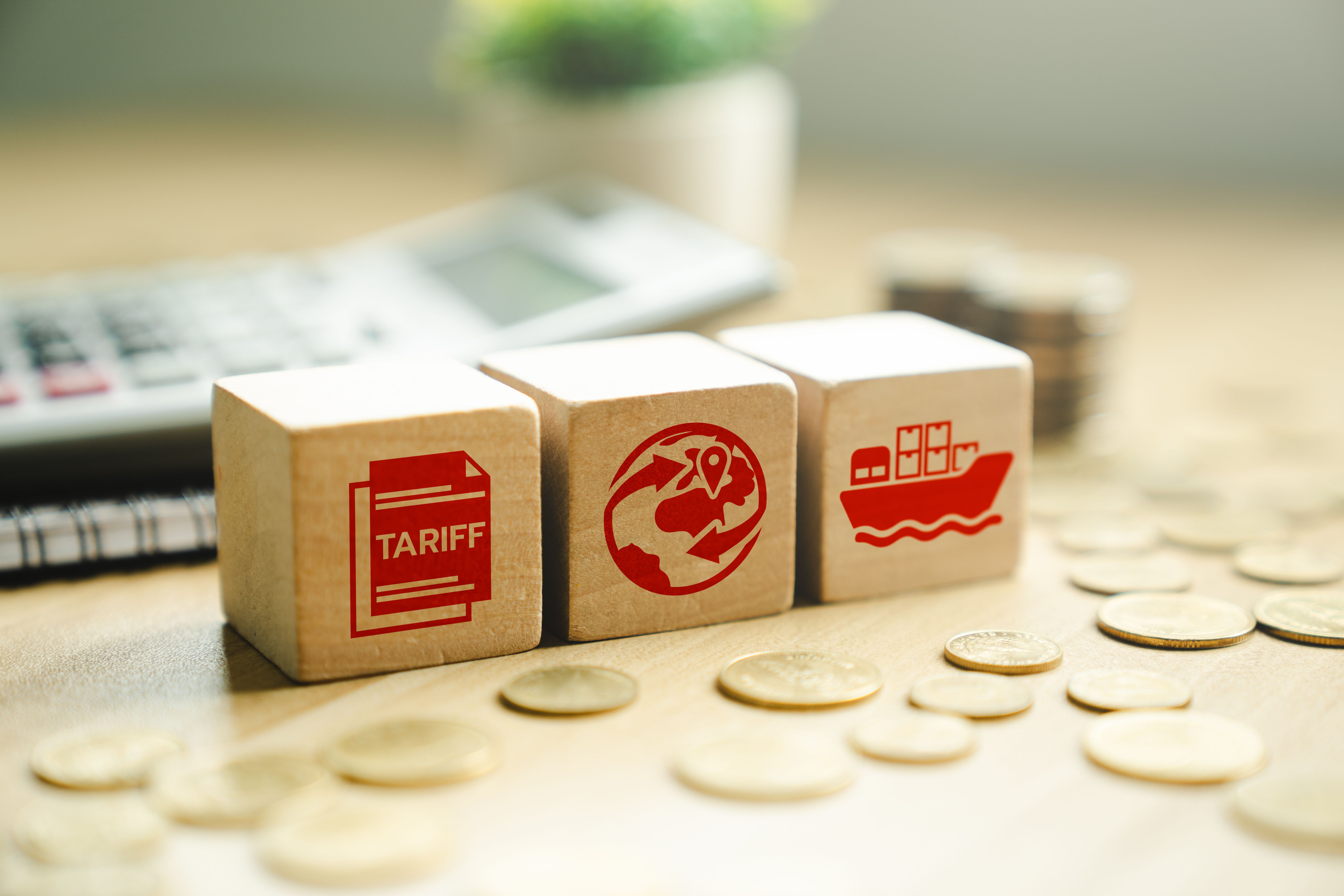 Global trade and tariff concept with red icons on wooden cubes, showing international shipping, customs documentation, and financial implications on import-export and global commerce Global trade and tariff concept with red icons on wooden cubes, showing international shipping, customs documentation, and financial implications on import-export and global commerce