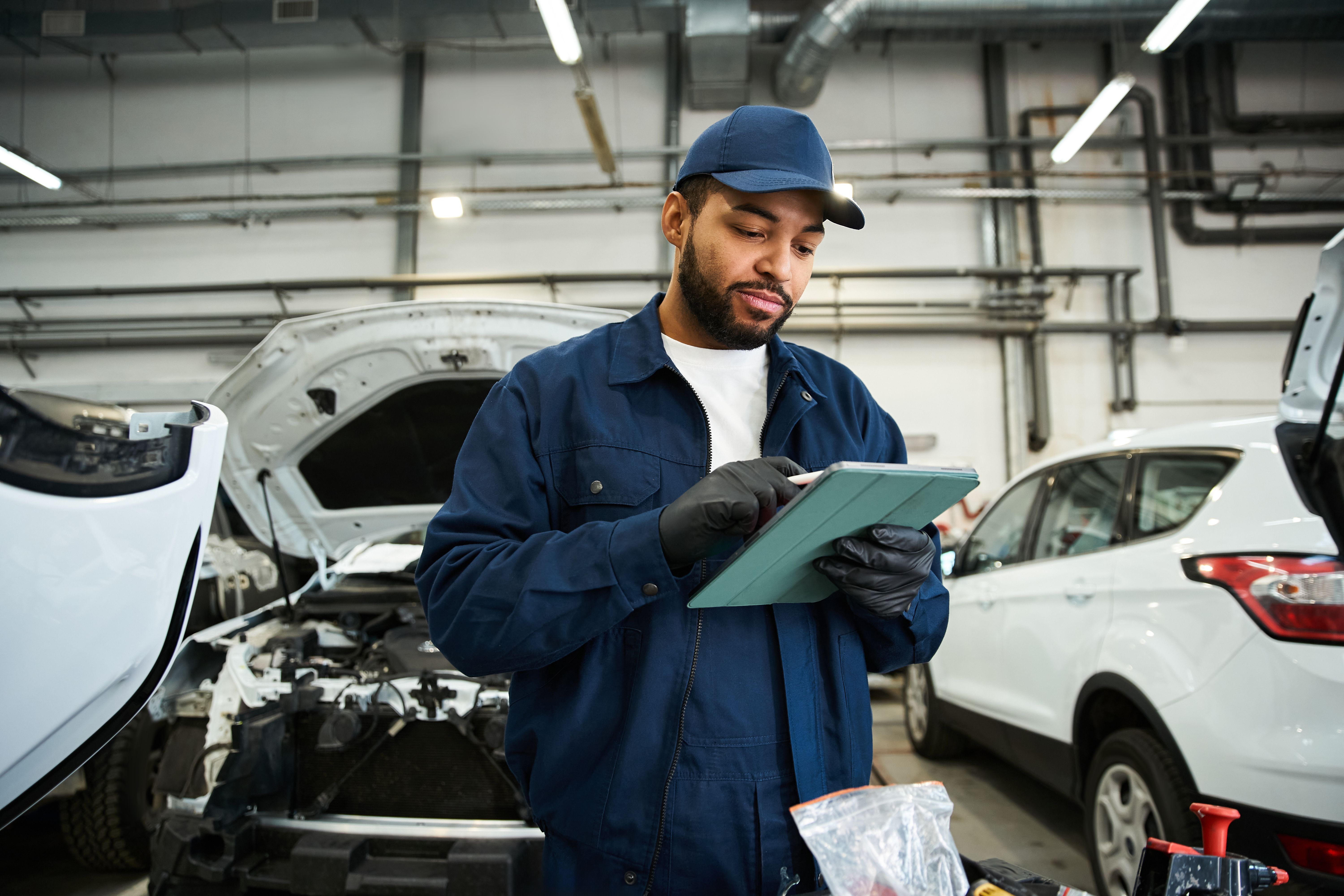 Focused mechanic performing car maintenance at auto service center
