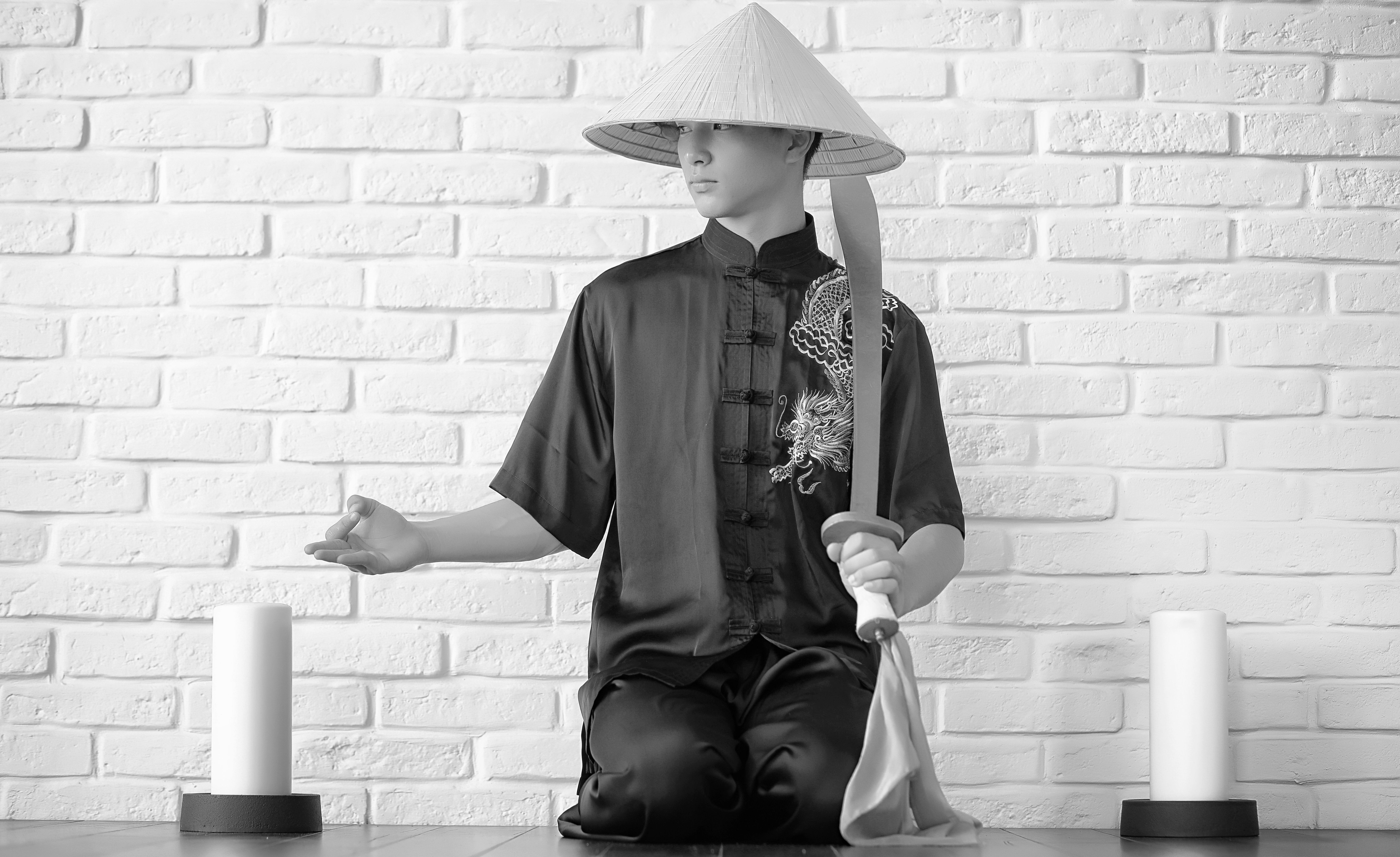 Asian novice on a white brick wall