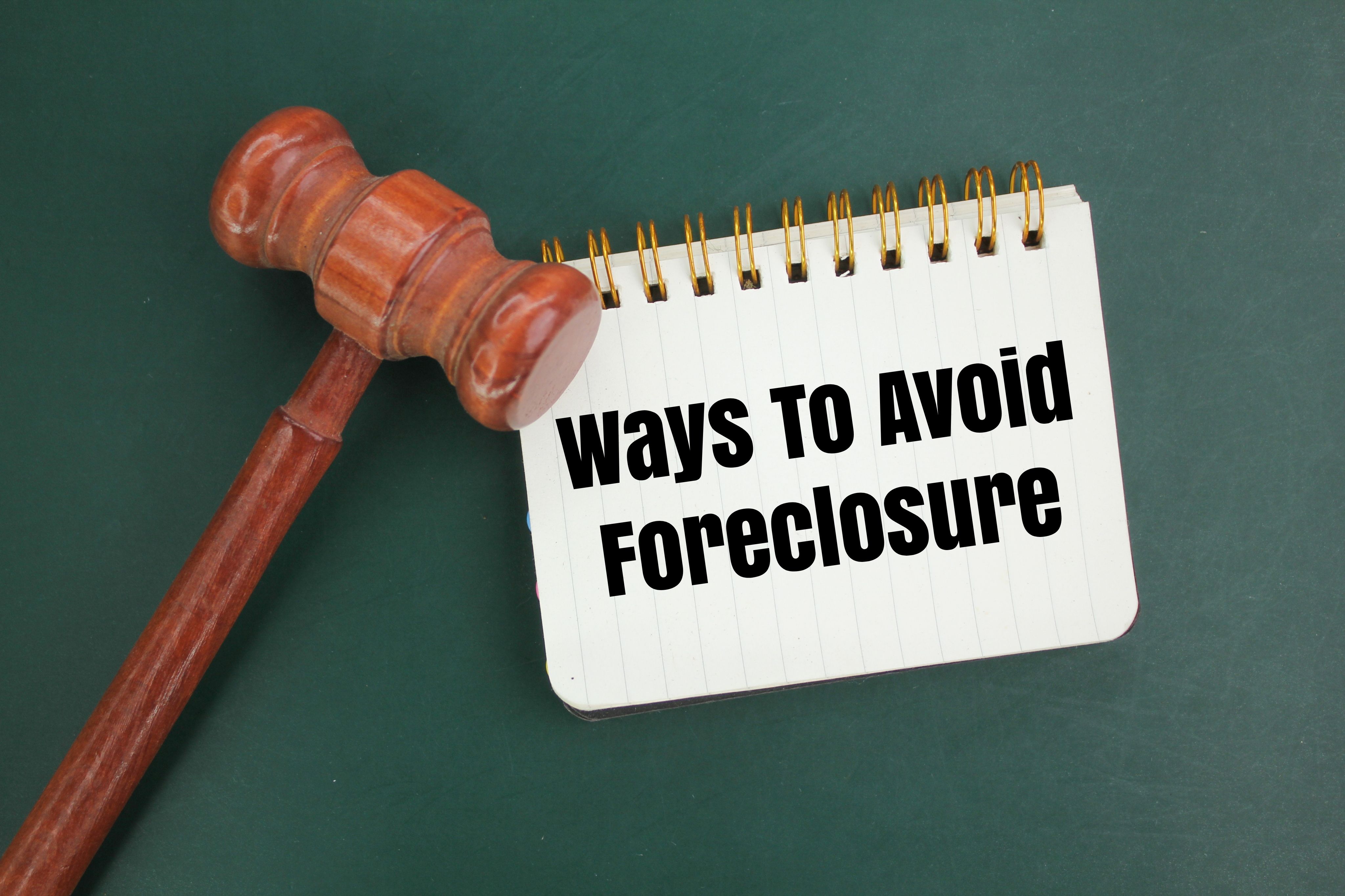 a judge's gavel and a notebook with the words Ways to Avoid Foreclosure. concept of seizure a judge's gavel and a notebook with the words Ways to Avoid Foreclosure. concept of seizure