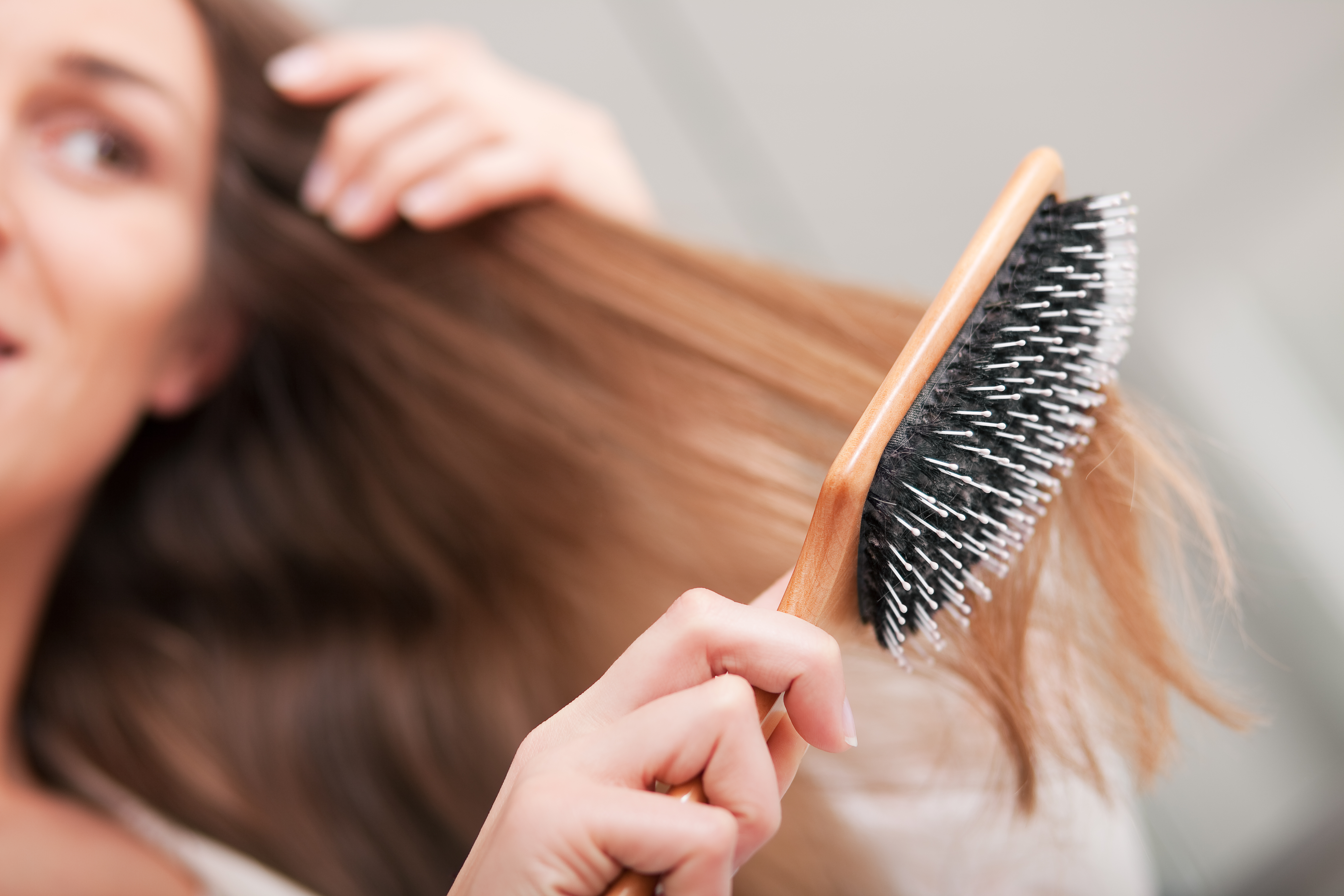 Young woman brushing her hair