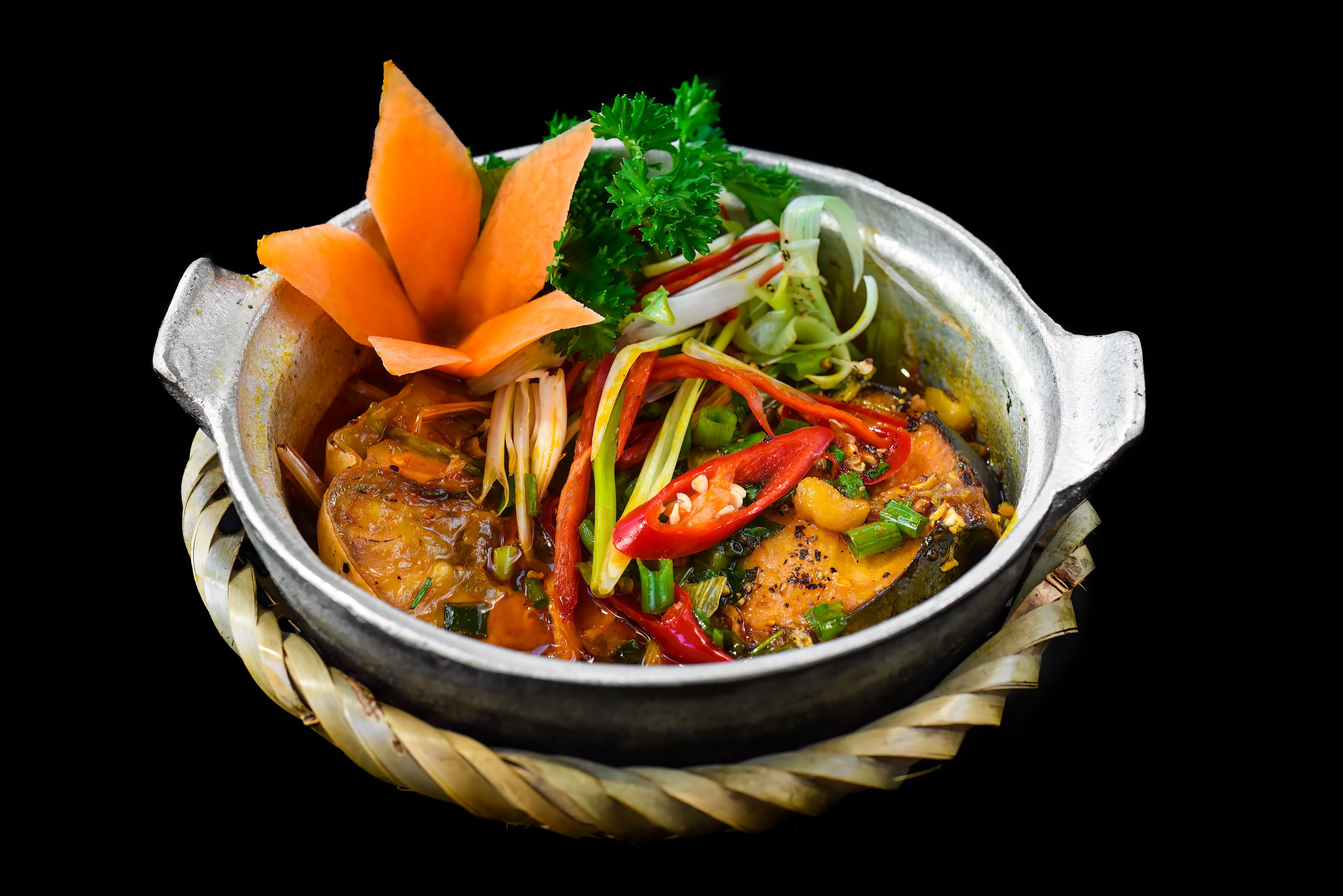 Vietnamese fried Mackerel fish with sauce on black background