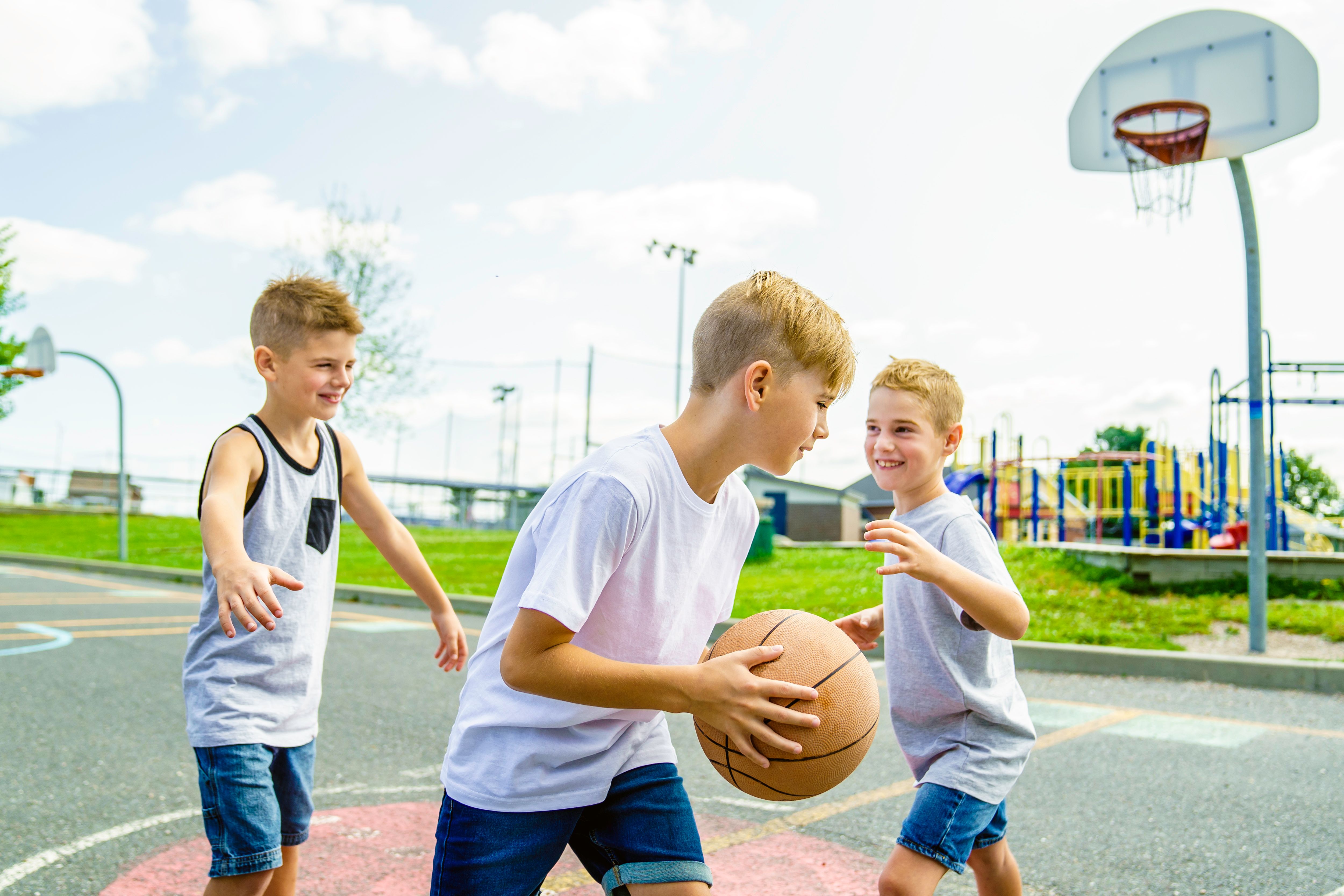 Young Boys brother Playing Basketball on the summer time