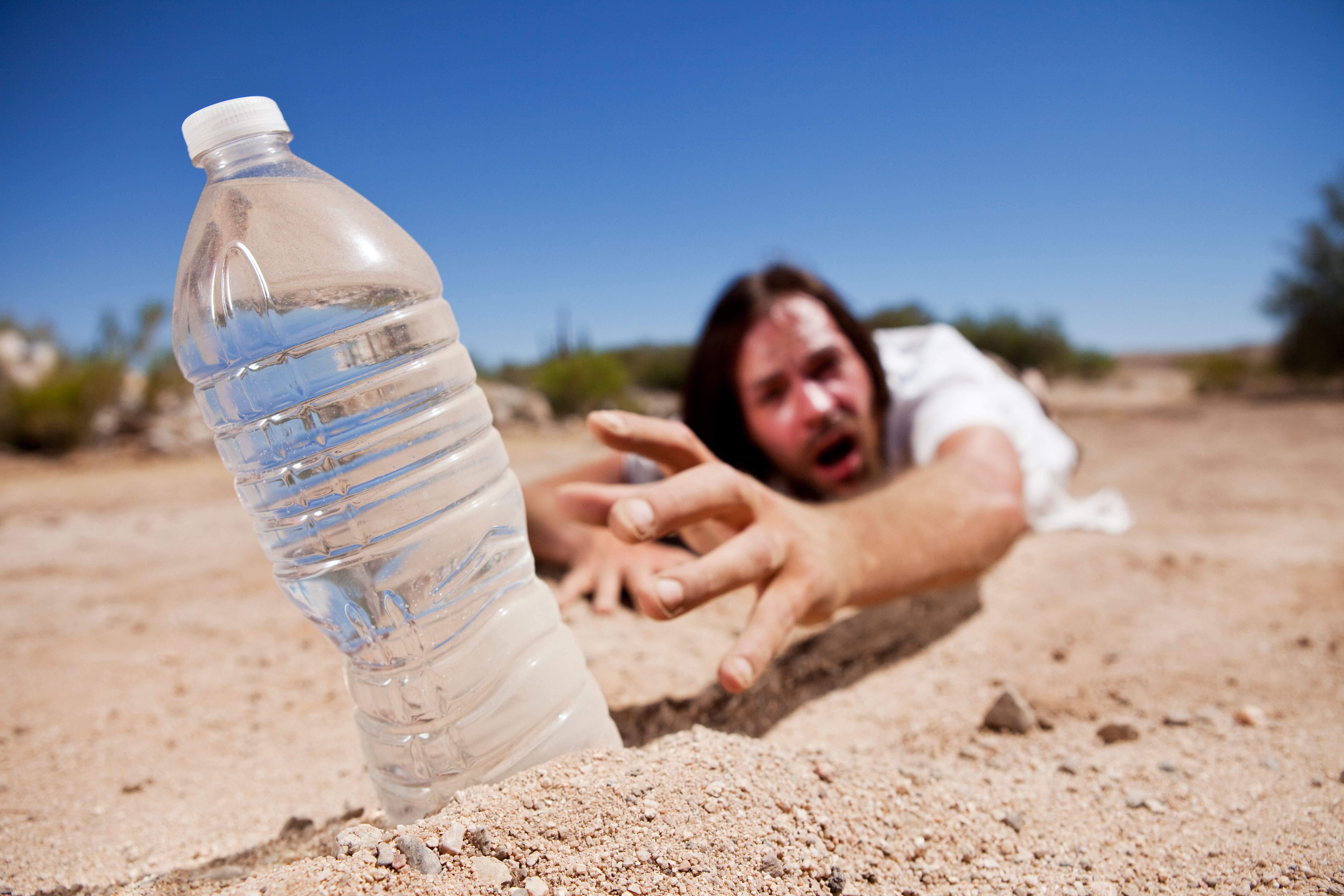 Man in Desert Reaching for Water