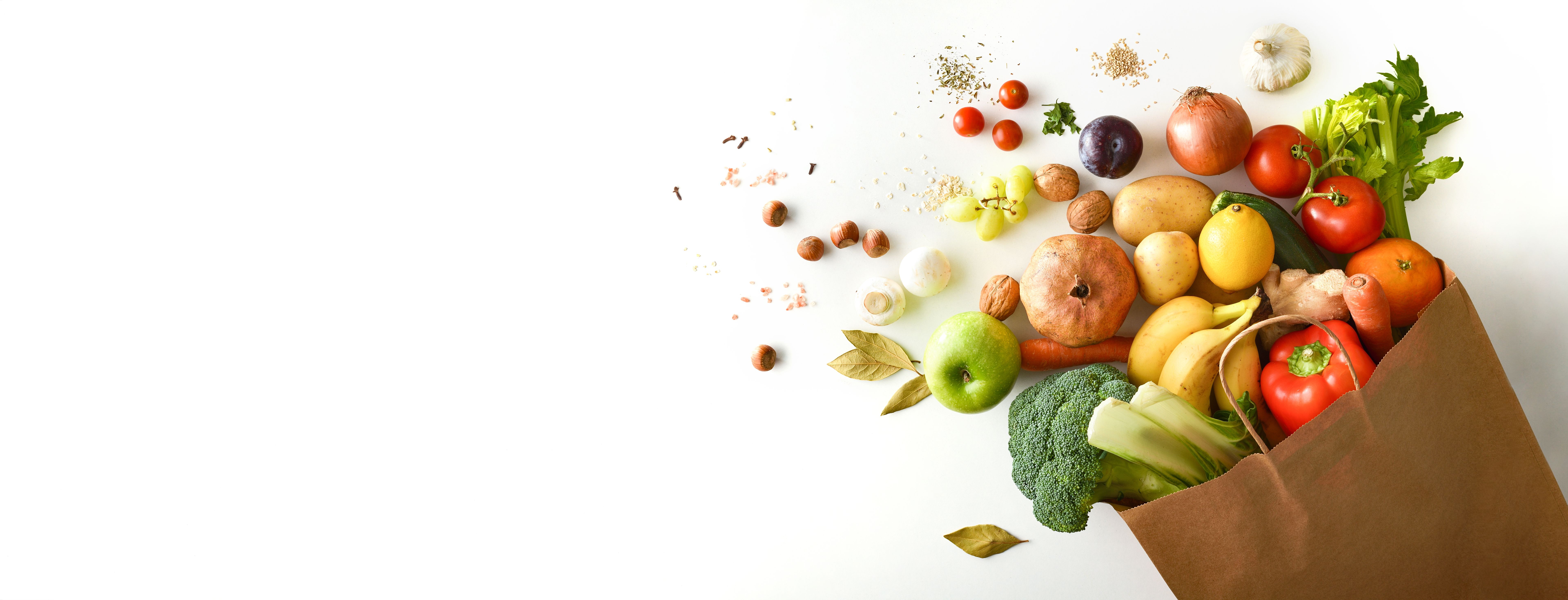 Background shopping bag with fruits and vegetables on white table