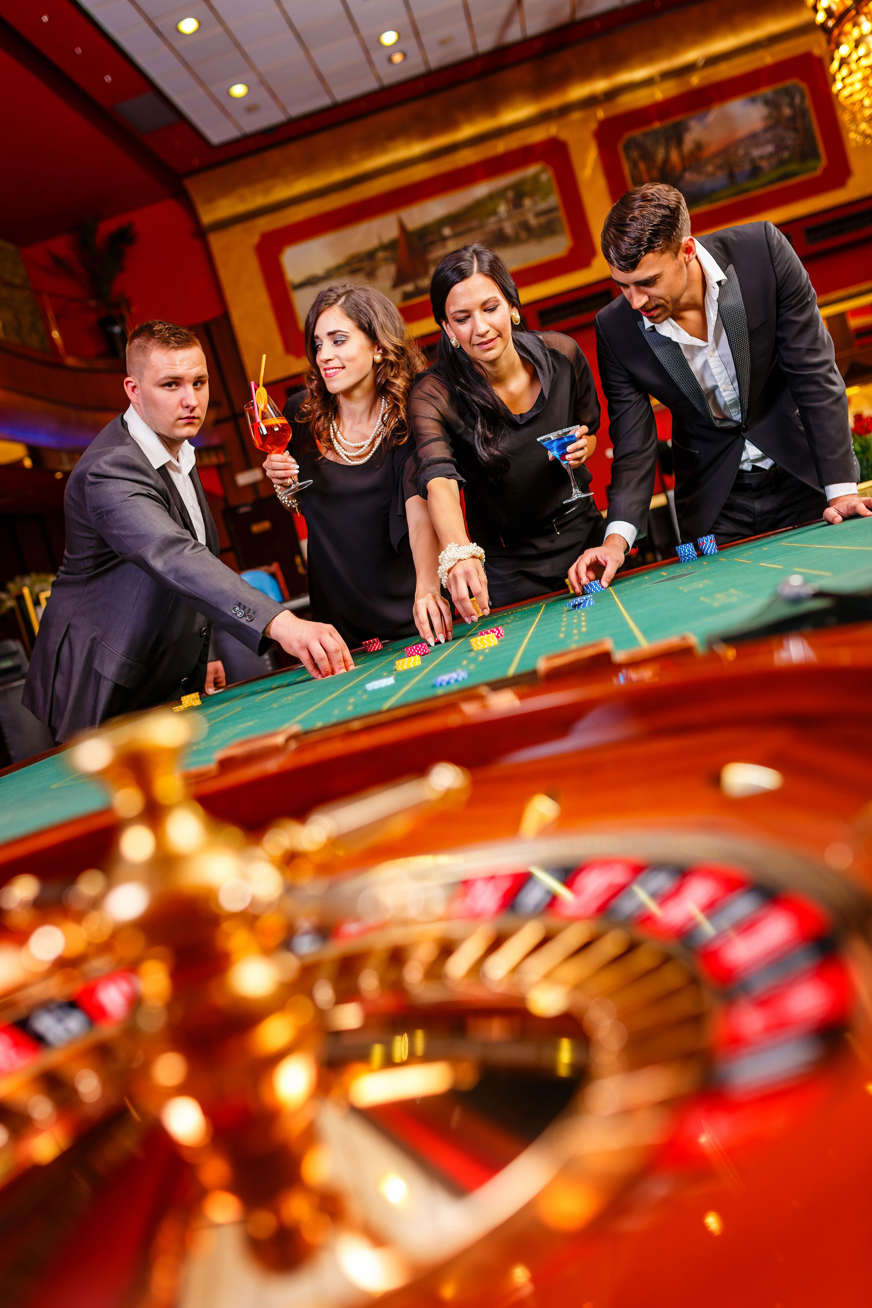 Friends playing roulette in casino Friends playing roulette in casino