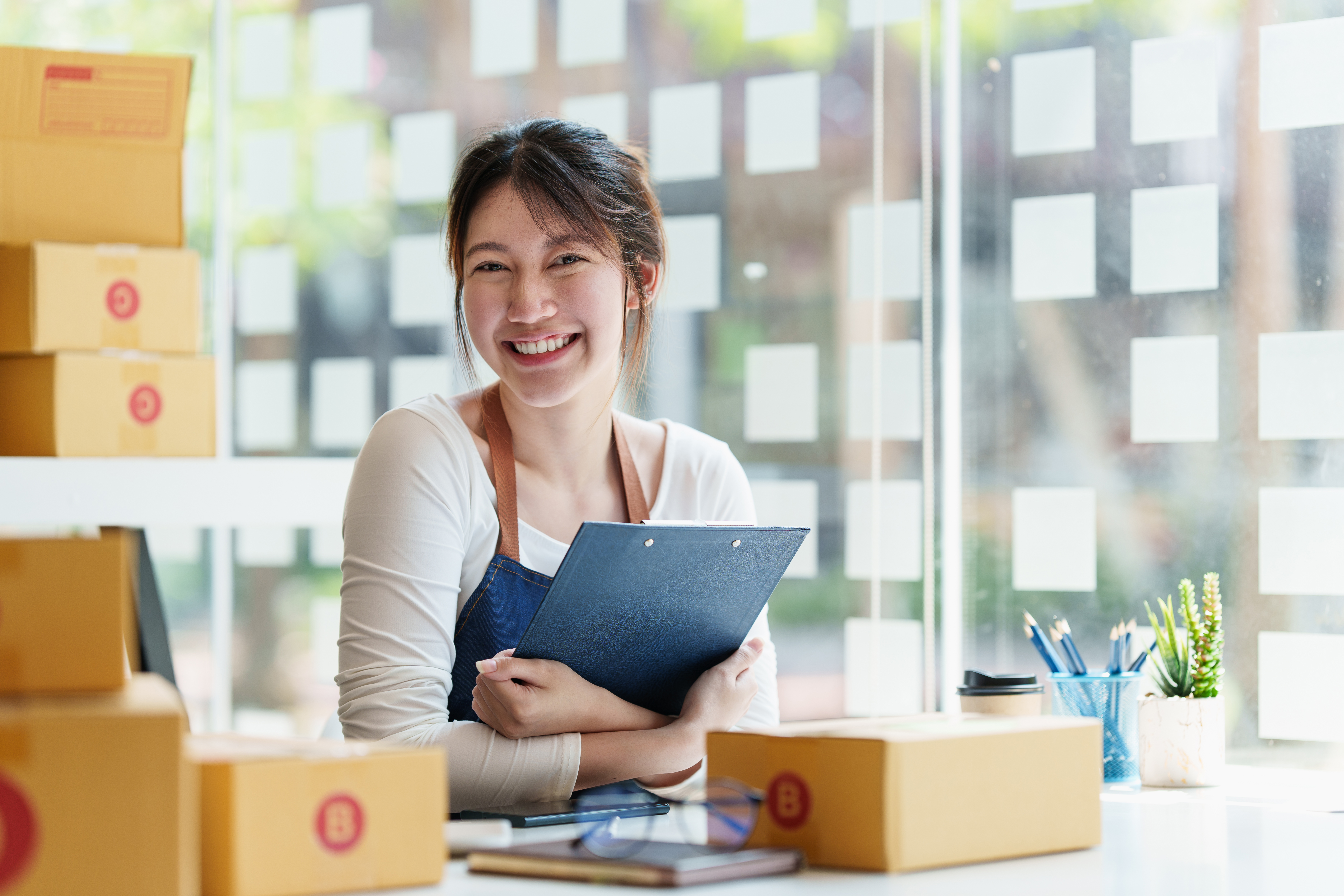 Young asian freelance packing boxes for commercial. SME e commerce concept.