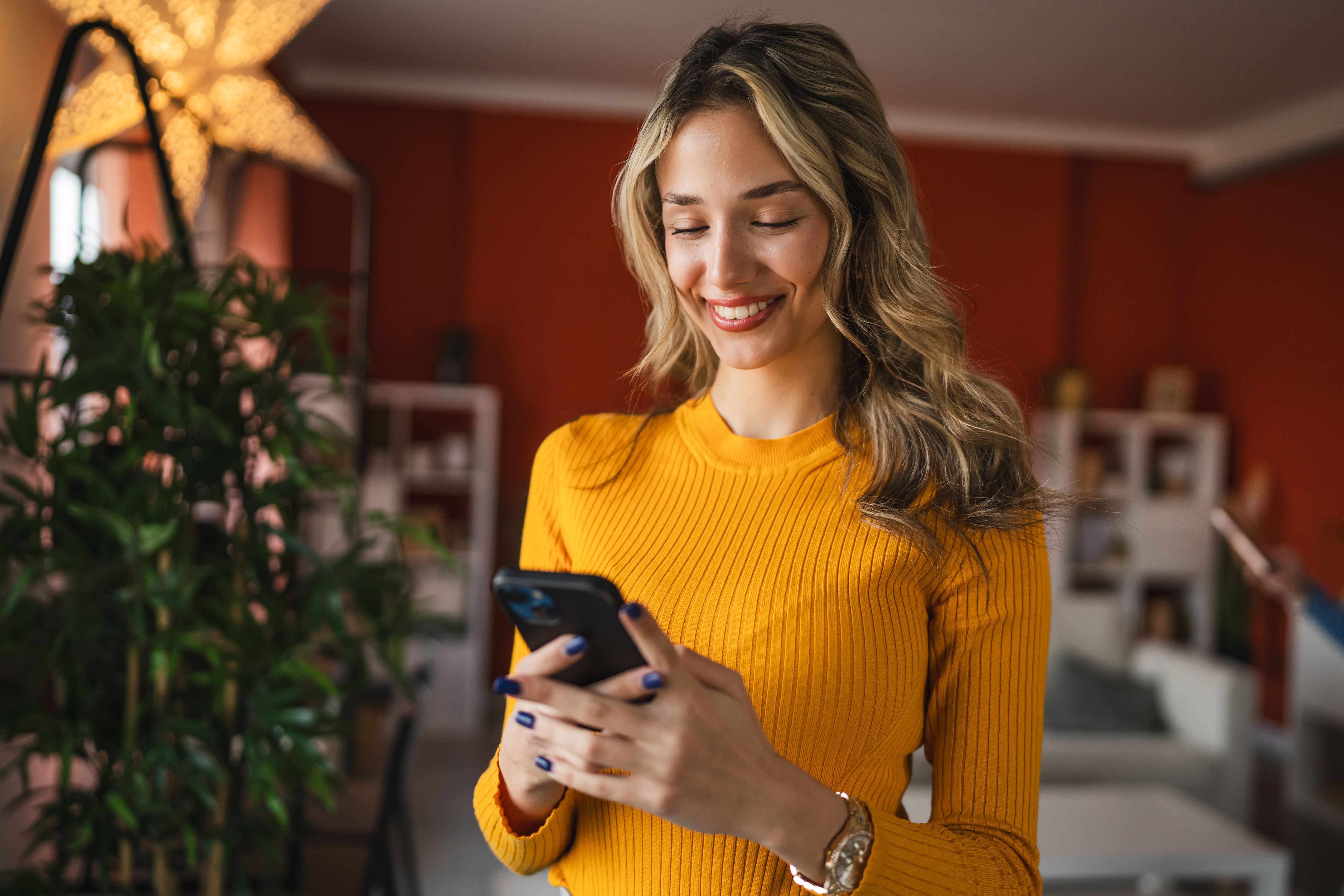 high school blondie girl with use mobile phone at home