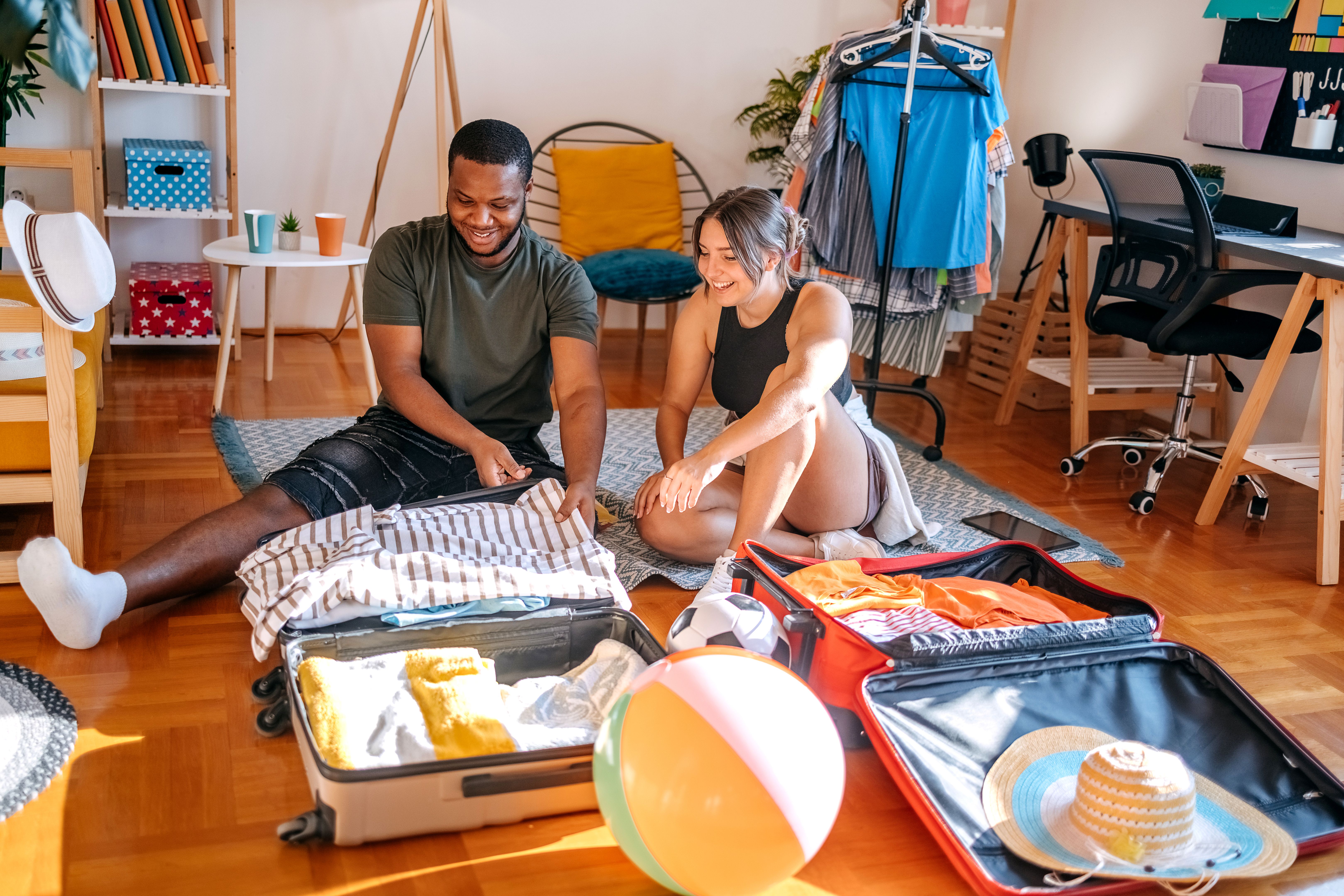 Couple packing suitcase for travel Couple packing suitcase for travel