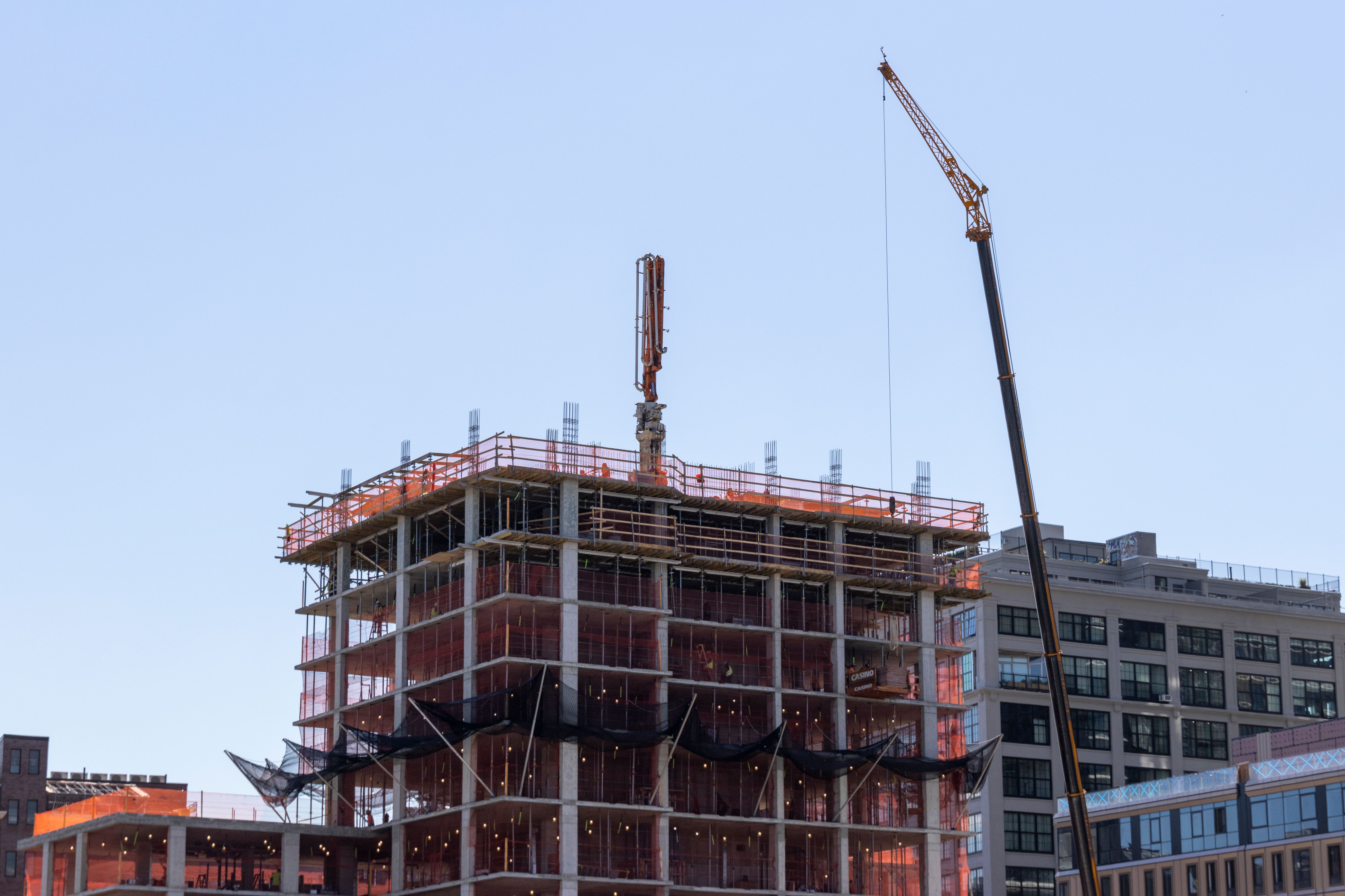 Construction of a modern skyscraper along the waterfront in New York City showcasing urban development