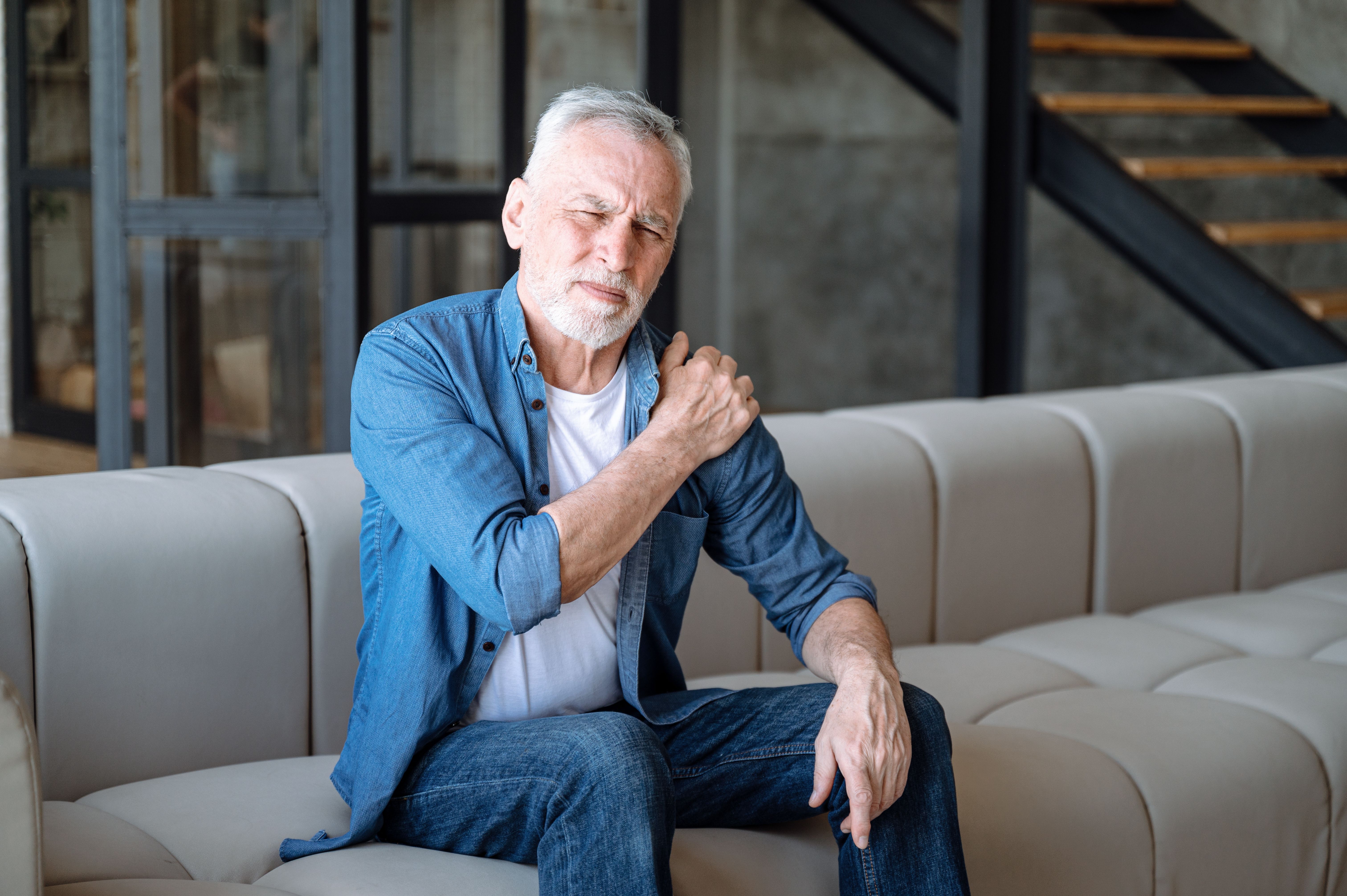 Senior man suffering from pain in shoulder Senior man suffering from pain in shoulder