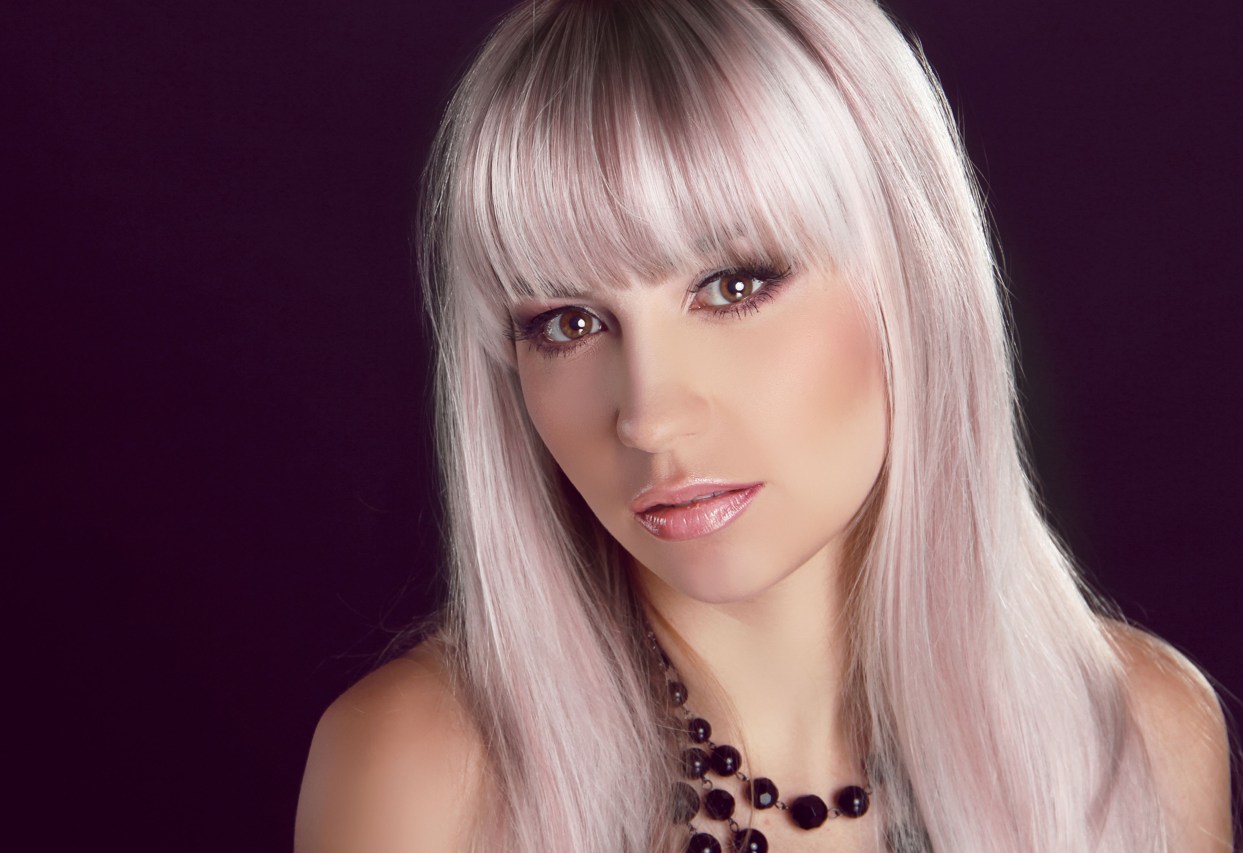 Portrait of young beautiful woman with colored glossy hair